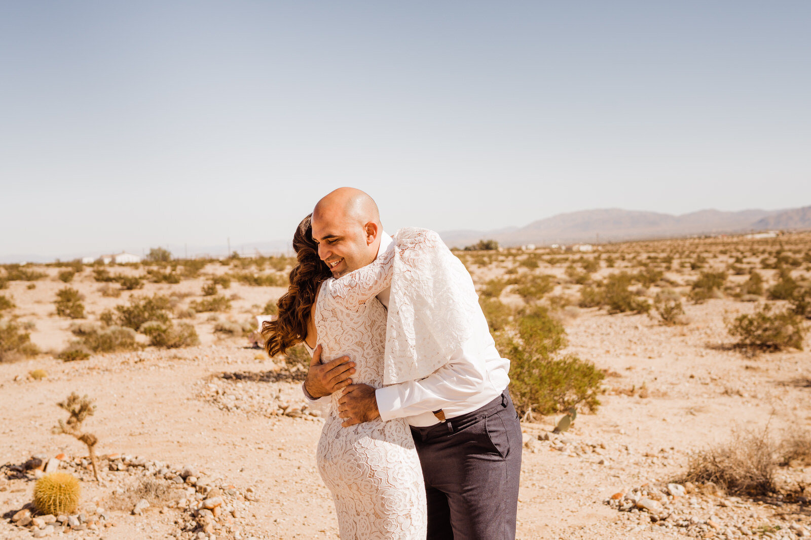 Man and woman hug after wedding first look in Joshua Tree | fun, nontraditional wedding photos by California Elopement Photographer Planner Kept Record | www.keptrecord.com