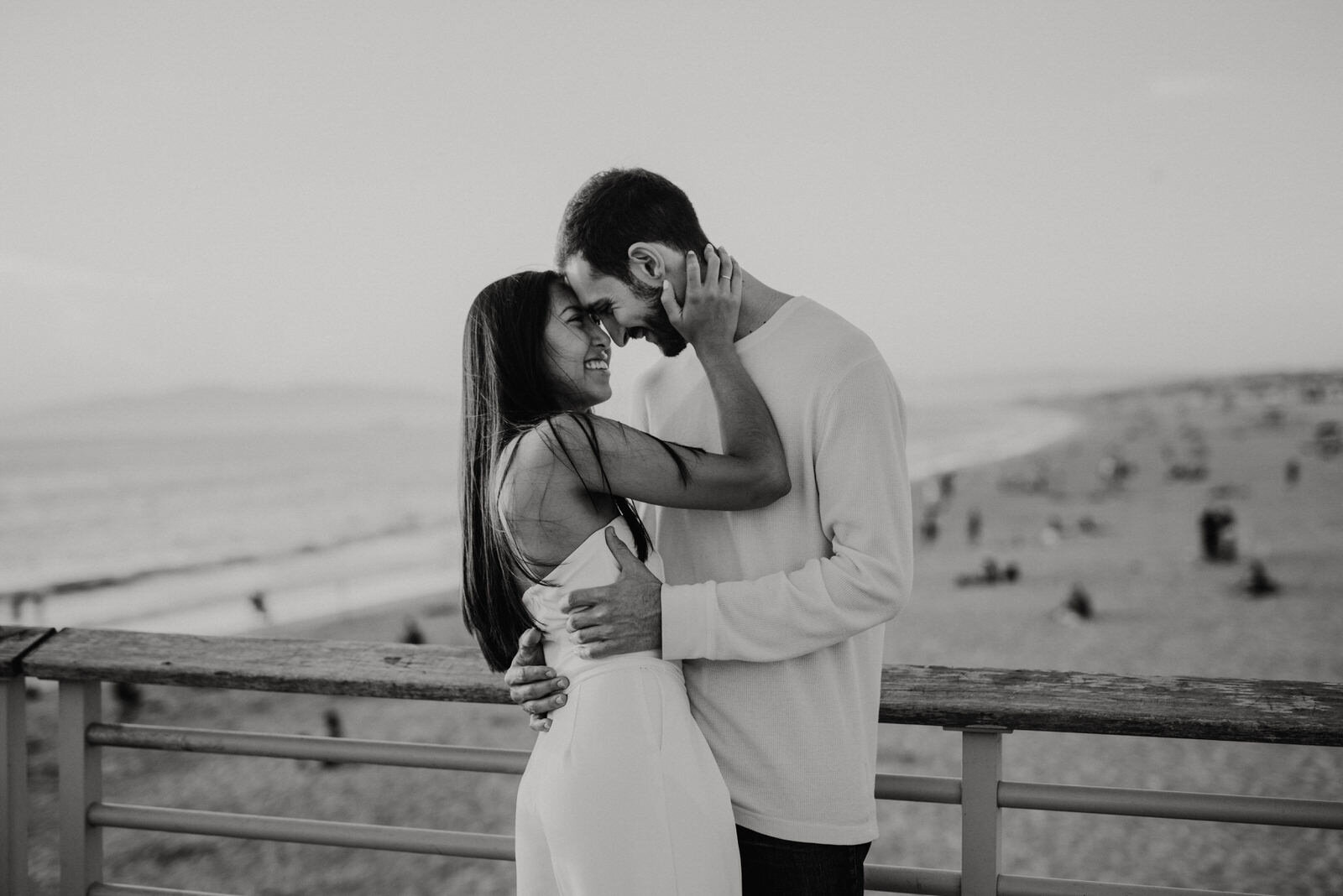 Pier engagement shoot poses | couple kissing | fun, nontraditional wedding photos by California Elopement Photographer Planner Kept Record | www.keptrecord.com