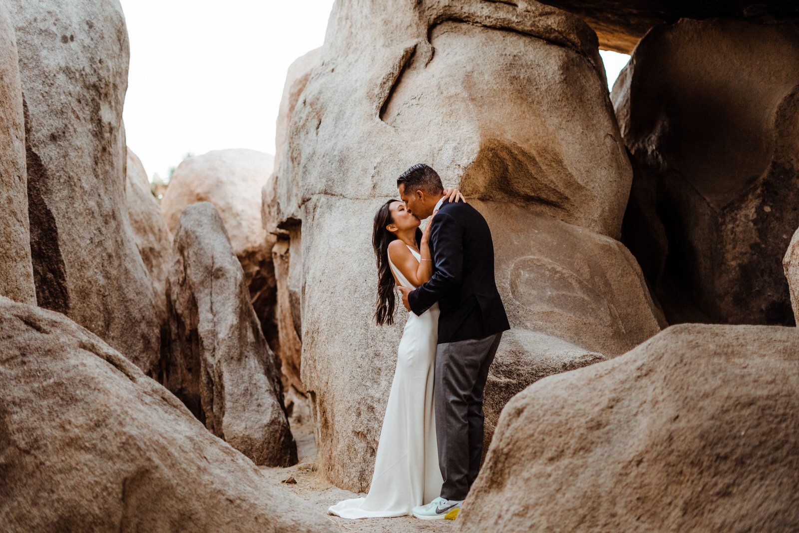 Joshua-Tree-Wedding-Photographer-Couple-Kiss-in-Boulder-Cave-in-National-Park.jpg