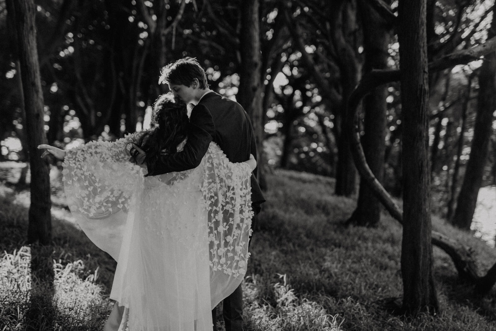 San-Francisco-Sutro-Baths-Elopement-Bride-in-flowy-cape-and-tall-groom-in-forest-by-sutro-heights (5).jpg