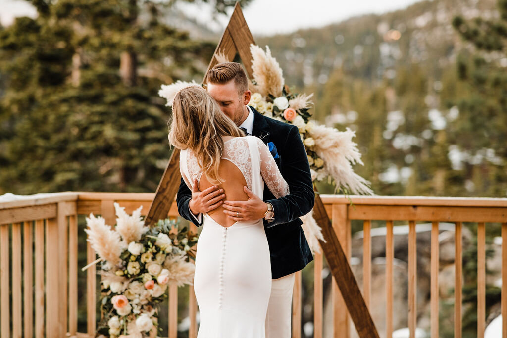 Snowy-Lake-Tahoe-Cabin-Elopement-Groom-holds-bride-in-intimate-hug.jpg