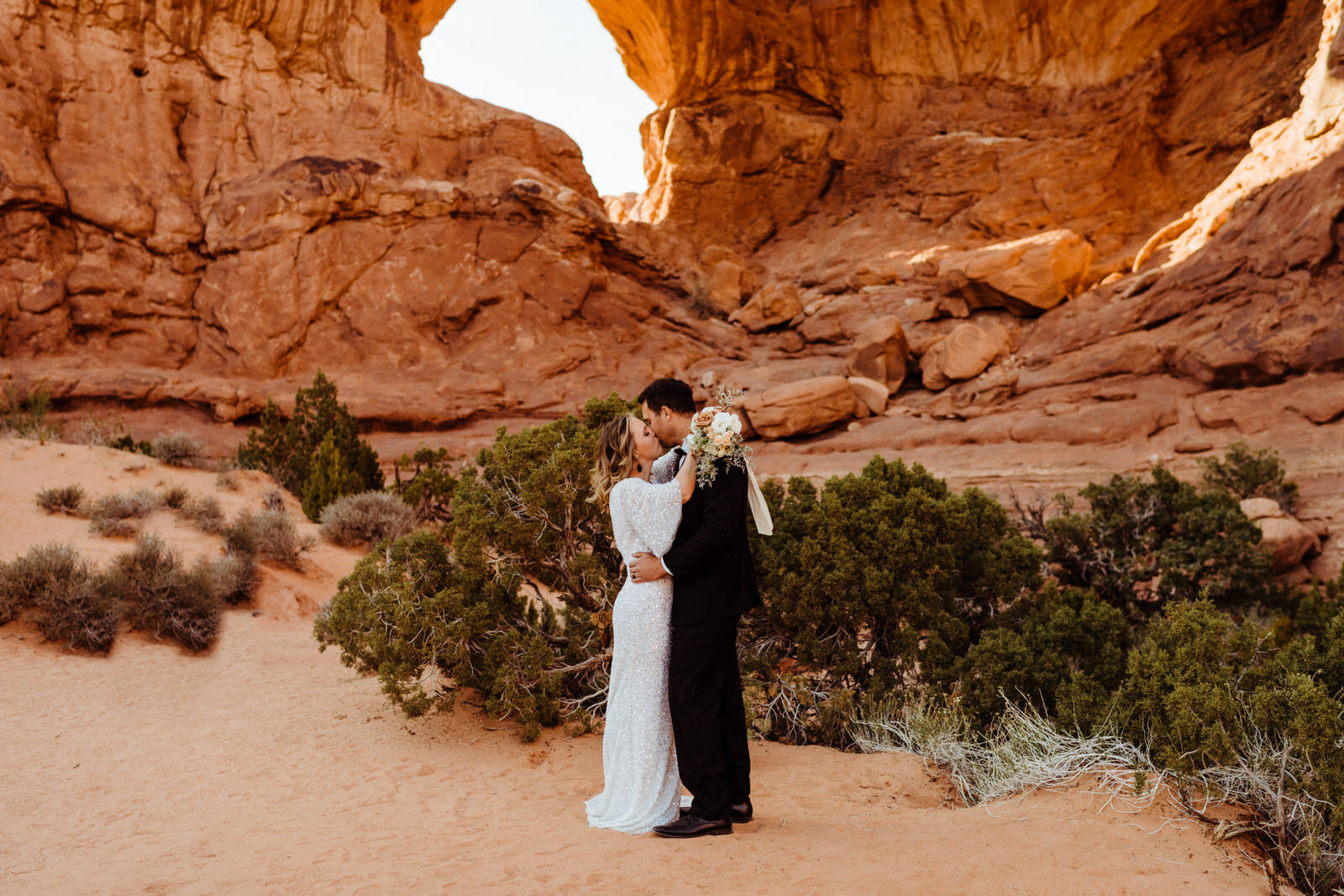 Arches-National-Park-Wedding-Glamorous-Bride-and-Groom-on-Trail (4).jpg
