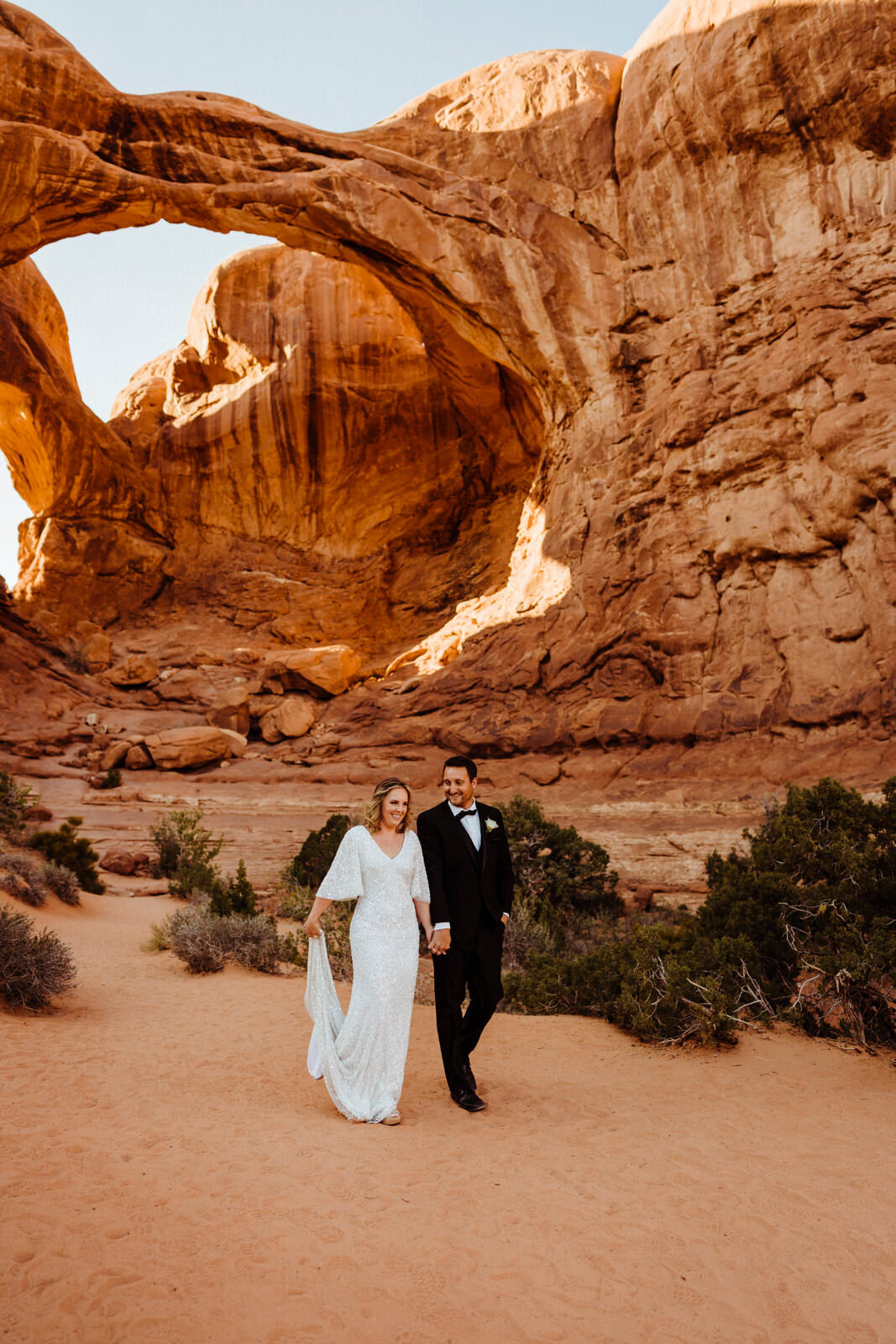 Arches-National-Park-Wedding-Glamorous-Bride-and-Groom-on-Trail (1).jpg