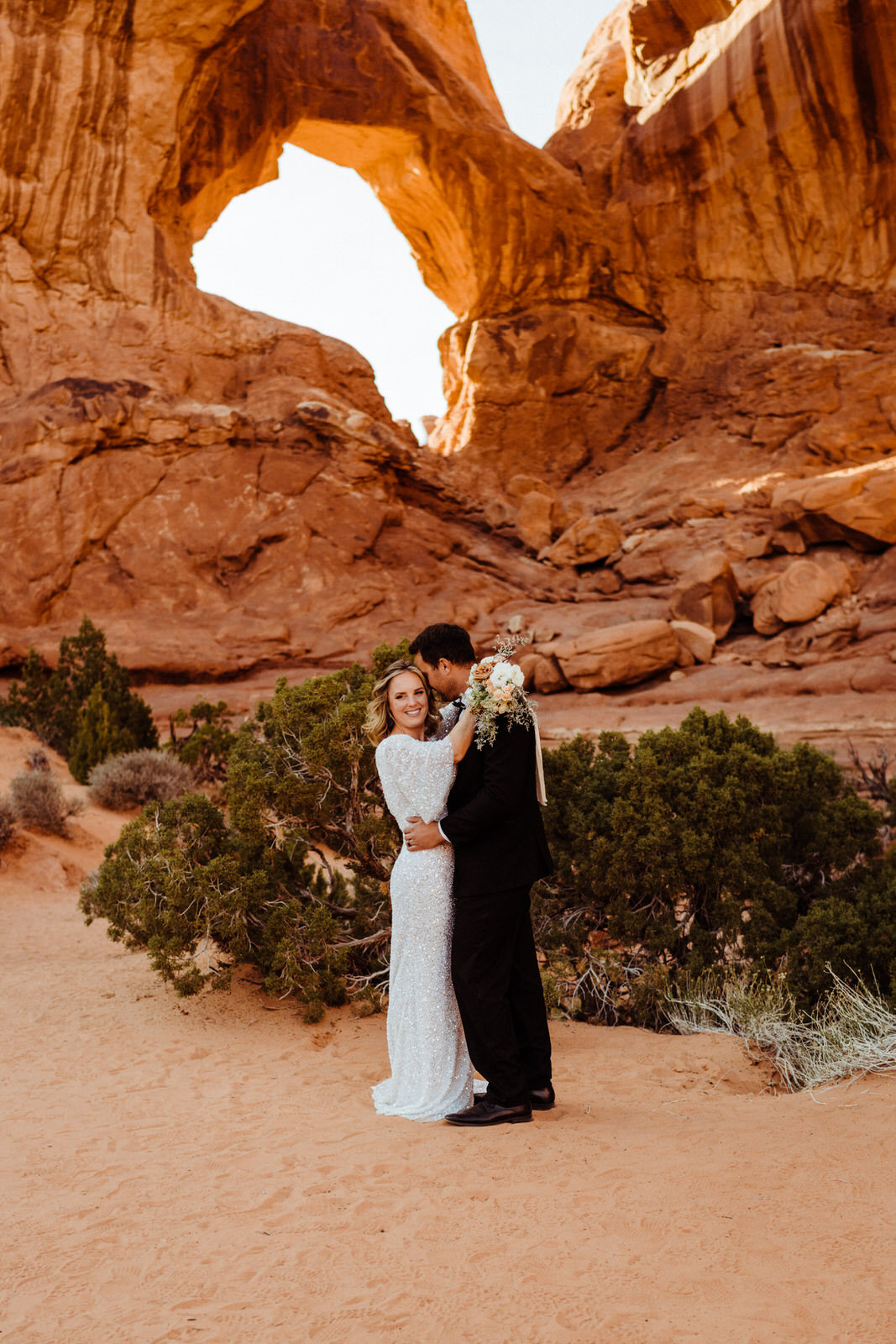 Arches-National-Park-Wedding-Glamorous-Bride-and-Groom-on-Trail (3).jpg