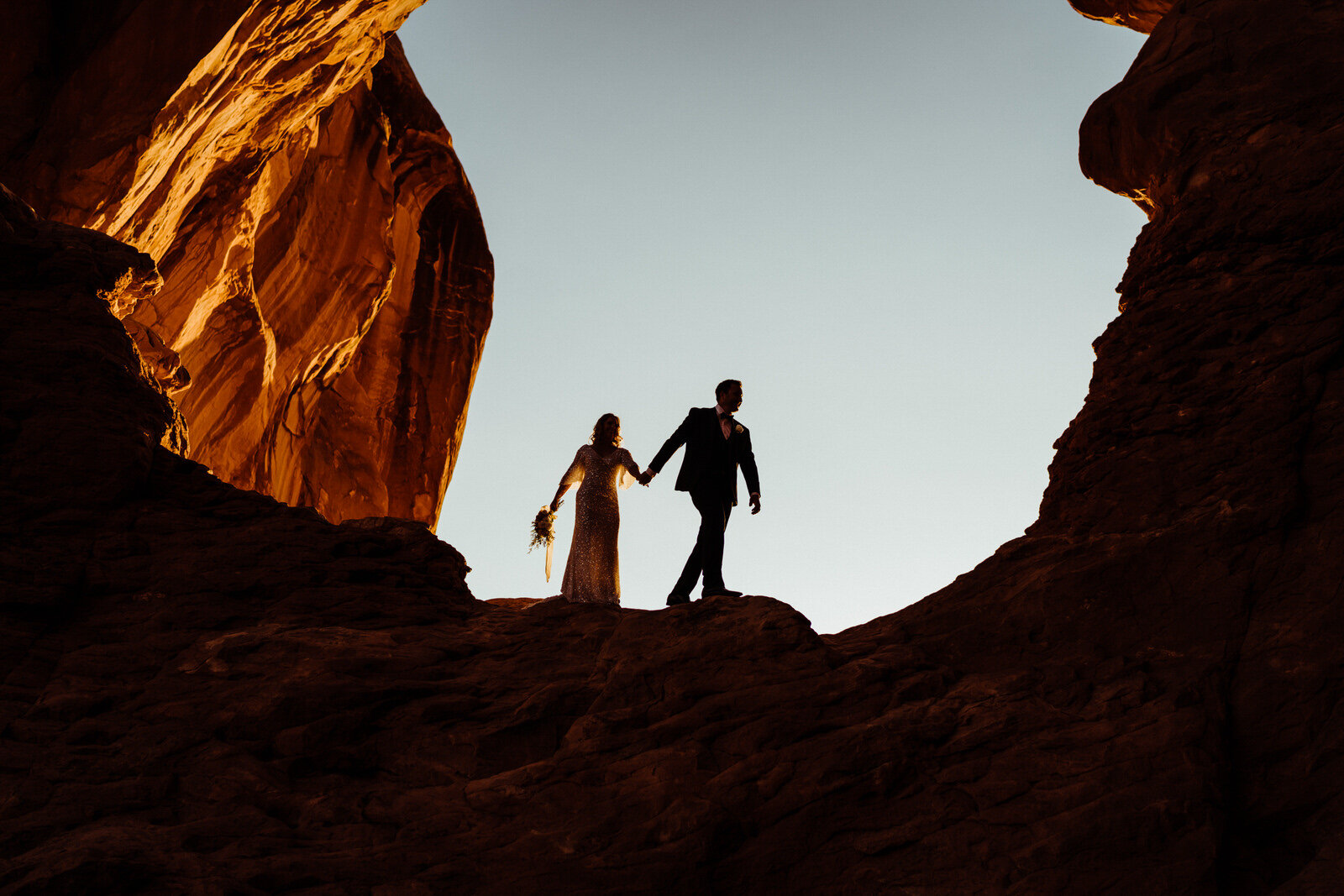 Arches-National-Park-Wedding-Silhouette-of-Bride-and-Groom-beneath-arch.jpg
