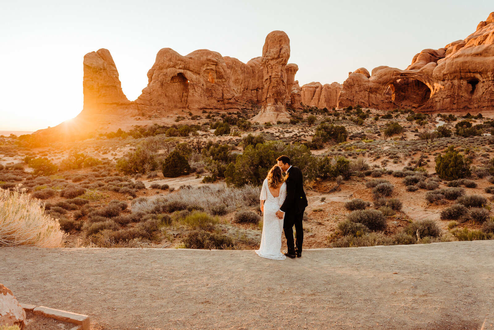 Arches-National-Park-Wedding-Bride-and-groom-watch-sunset-from-trail-after-ceremony (2).jpg