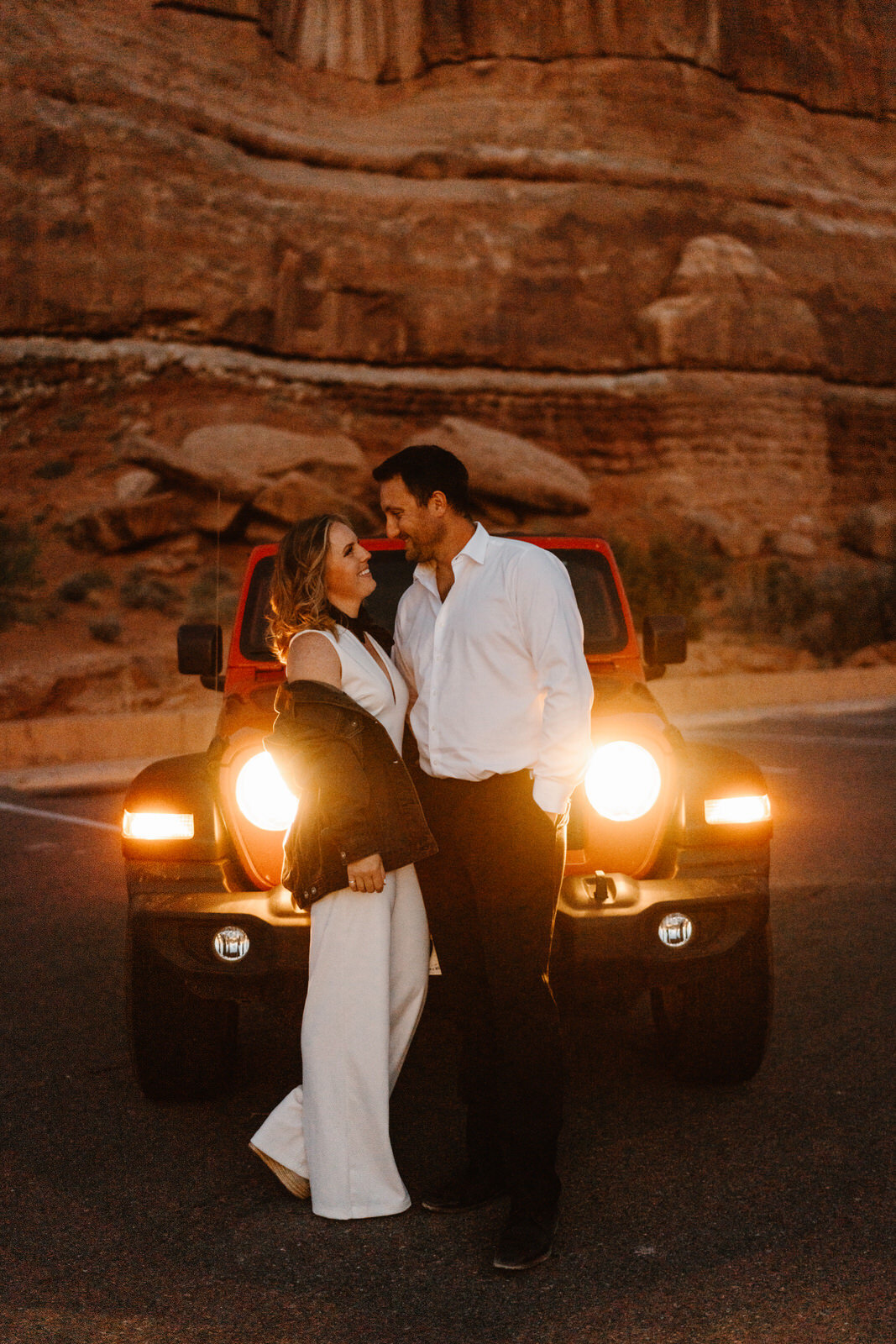 Moab-Jeep-Adventure-Elopement-Bride-and-Groom-with-Red-Jeep-Wrangler-at-sunset.jpg