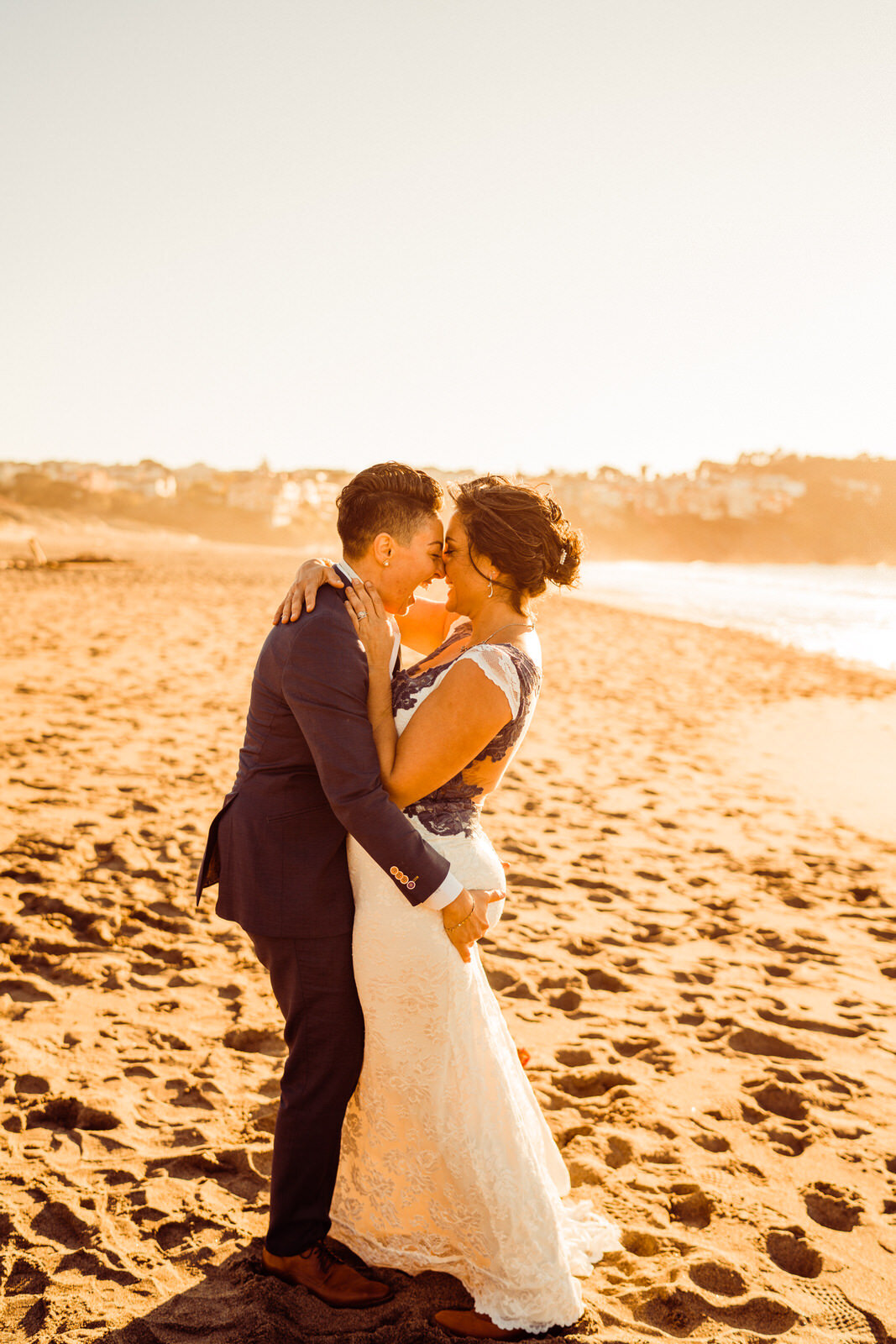 Baker-Beach-Same-Sex-Wedding-San-Francisco-Woman-in-Suit-Kissing-Bride-in-Dress.jpg