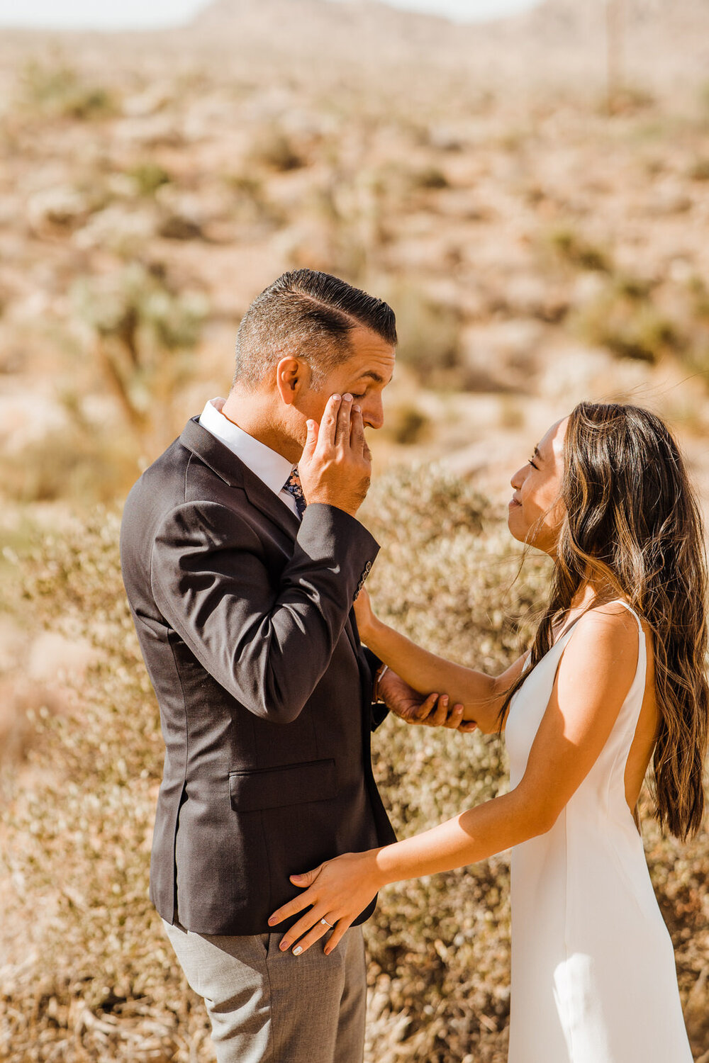 Groom wipes eyes at tearful emotional first look in Joshua Tree