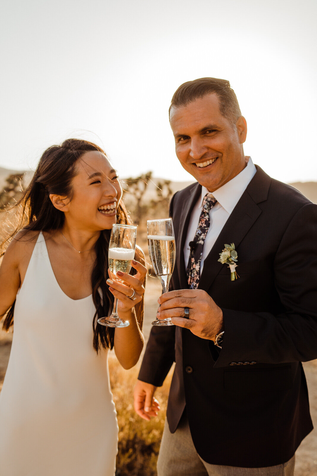 Asian American bride and Groom toast with Champagne after Joshua Tree Wedding Ceremony