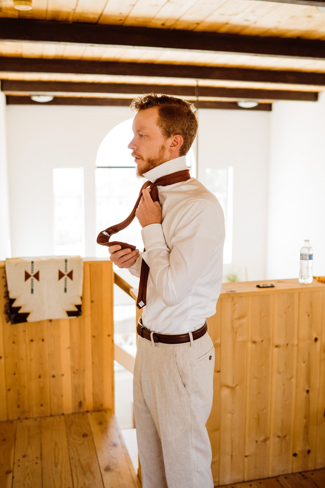 Fall-Wedding-in-Joshua-Tree-Groom-in-Tan-Suit-Getting-Ready-with-Star-Wars-Cufflinks (3).jpg