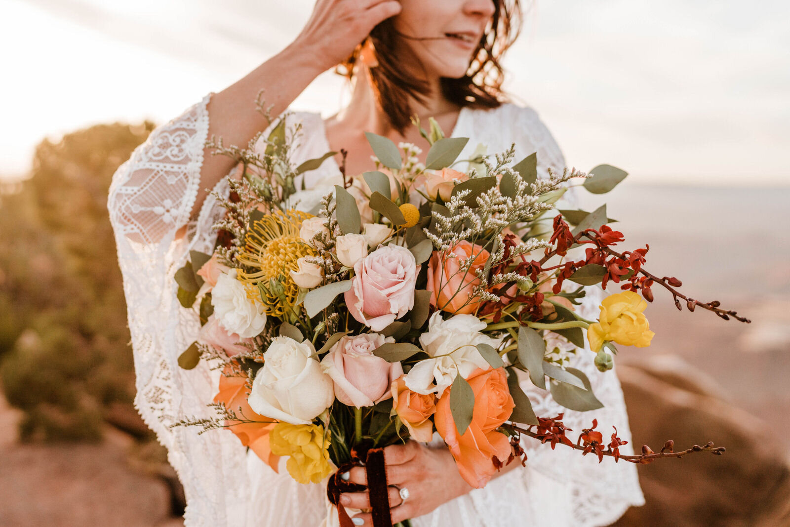 Bride at Hiking Sunrise Elopement in Canyonlands National Park | Bright Whimsical Bouquet | Moab Wedding Photographer Kept Record | www.keptrecord.com