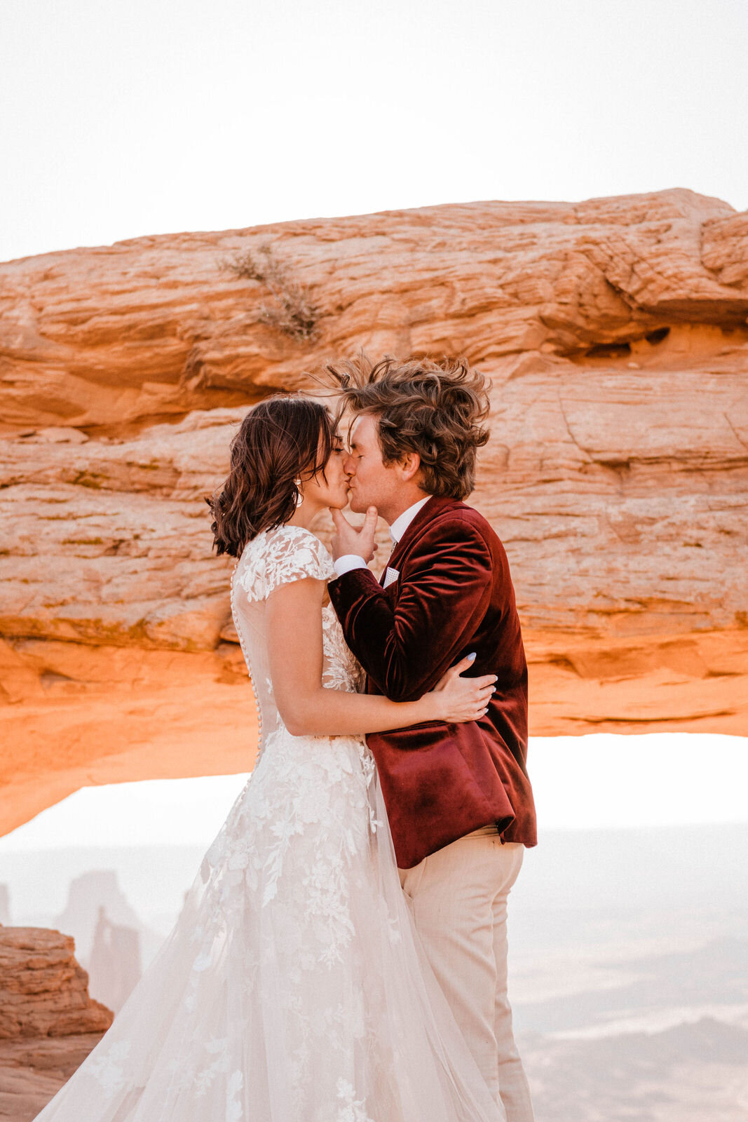 Bride and Groom at Canyonlands Mesa Arch | Groom in Red Velvet Suit | Moab Wedding Photographer Kept Record | www.keptrecord.com
