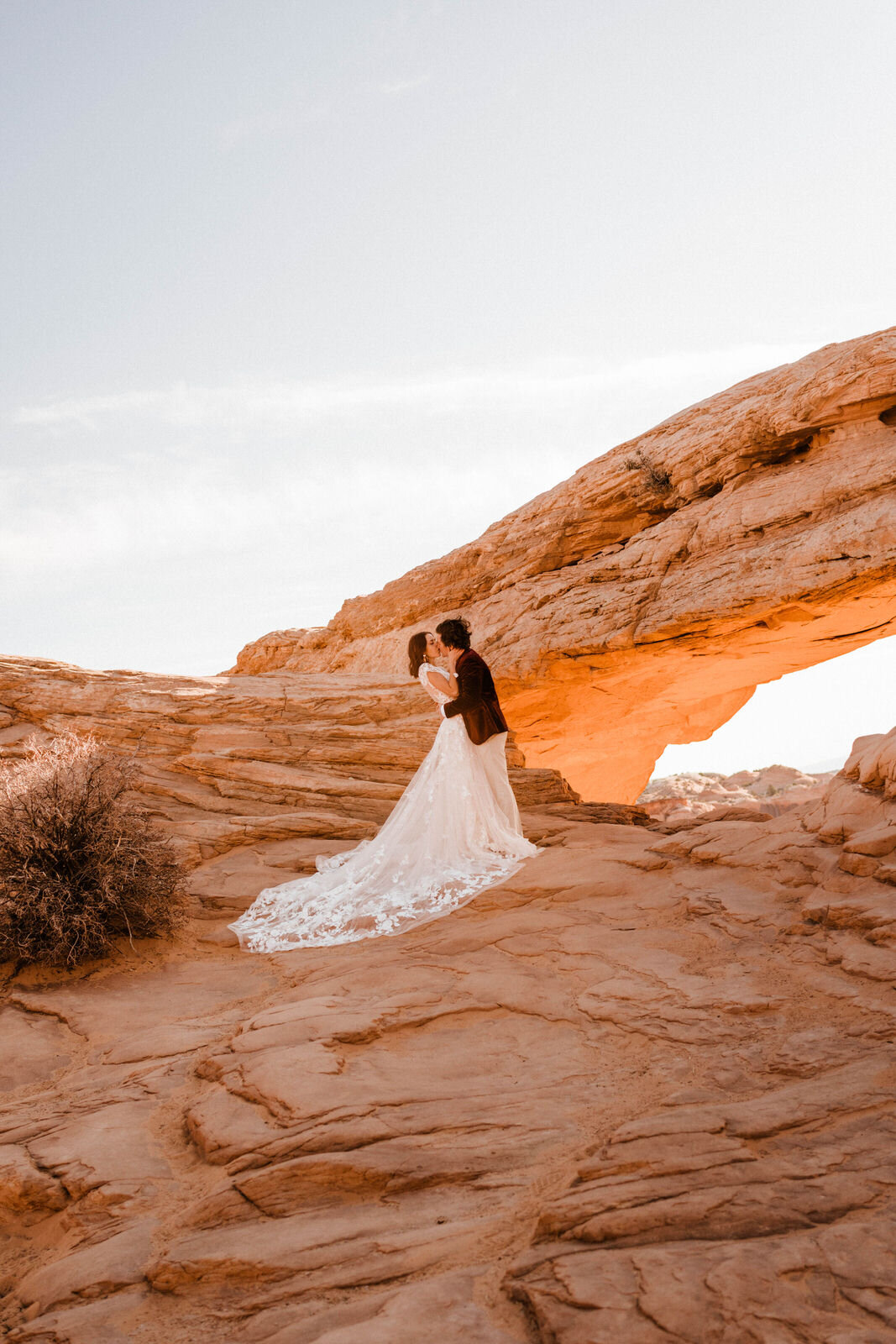 Bride and Groom at Canyonlands Mesa Arch | Groom in Red Velvet Suit | Moab Wedding Photographer Kept Record | www.keptrecord.com