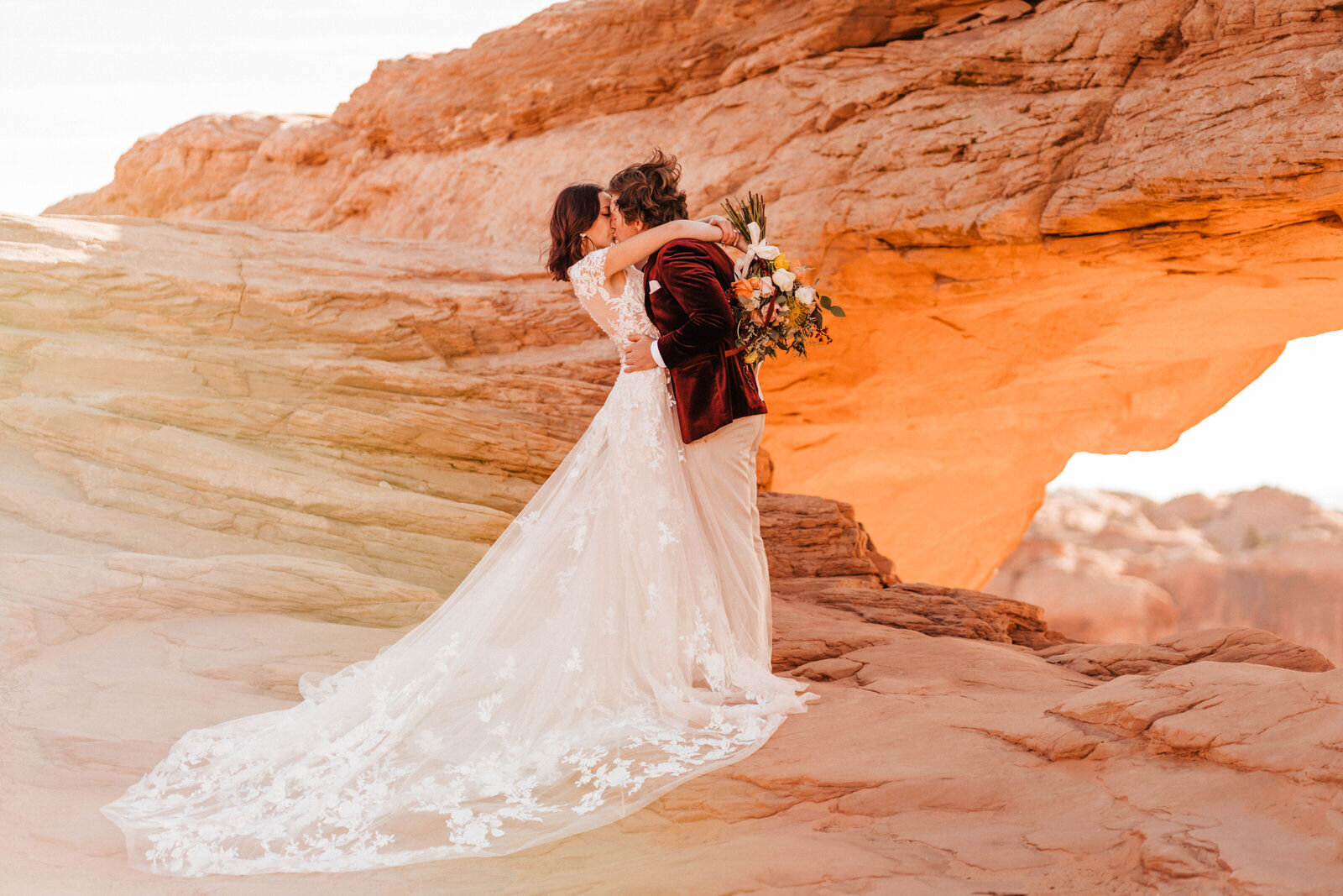 Bride and Groom at Canyonlands Mesa Arch | Groom in Red Velvet Suit | Moab Wedding Photographer Kept Record | www.keptrecord.com