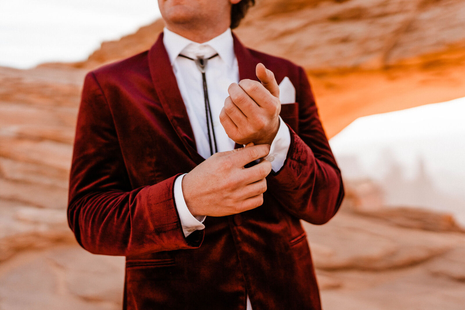 Bride and Groom at Canyonlands Mesa Arch | Groom in Red Velvet Suit | Moab Wedding Photographer Kept Record | www.keptrecord.com