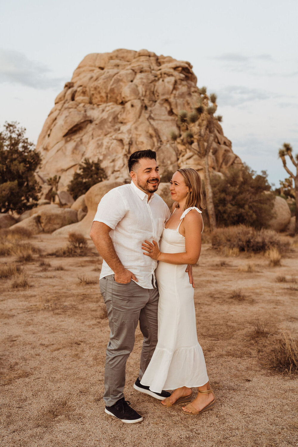 Sunrise Engagement Session in Joshua Tree, California - Couple stands in the desert - Photos by Adventurous Elopement + Wedding Photographer Kept Record | www.keptrecord.com
