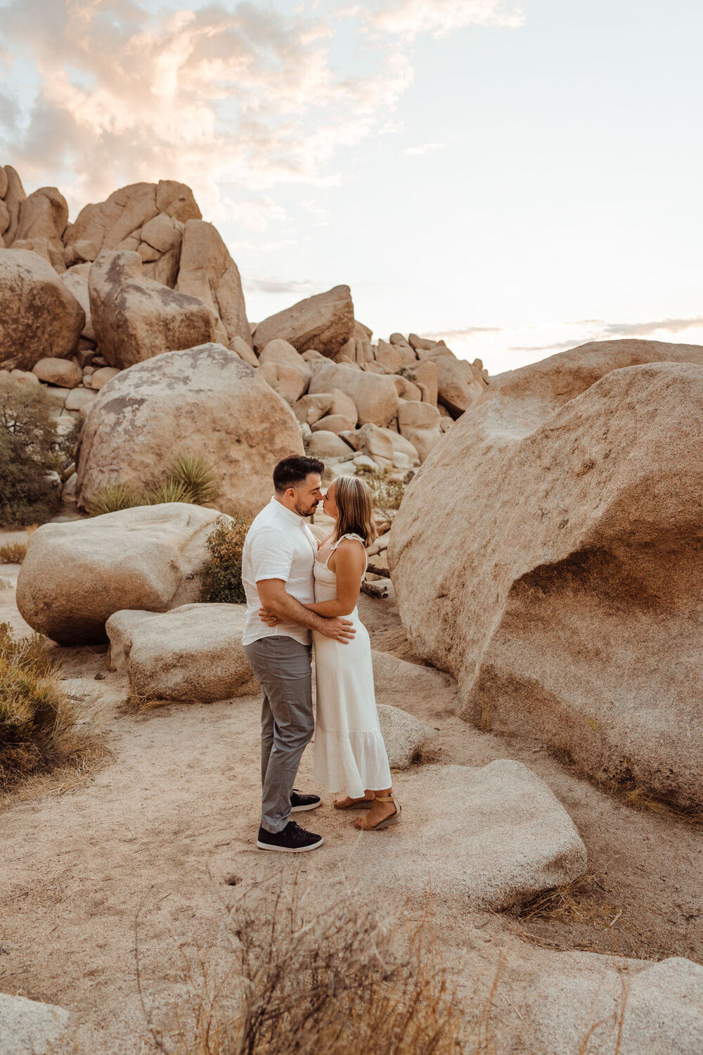 Sunrise Engagement Session in Joshua Tree, California - Couple with Boulders - Photos by Adventurous Elopement + Wedding Photographer Kept Record | www.keptrecord.com