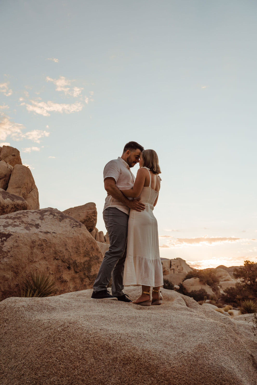 Sunrise Engagement Session in Joshua Tree, California - Couple Silhouetted By Clouds- Photos by Adventurous Elopement + Wedding Photographer Kept Record | www.keptrecord.com