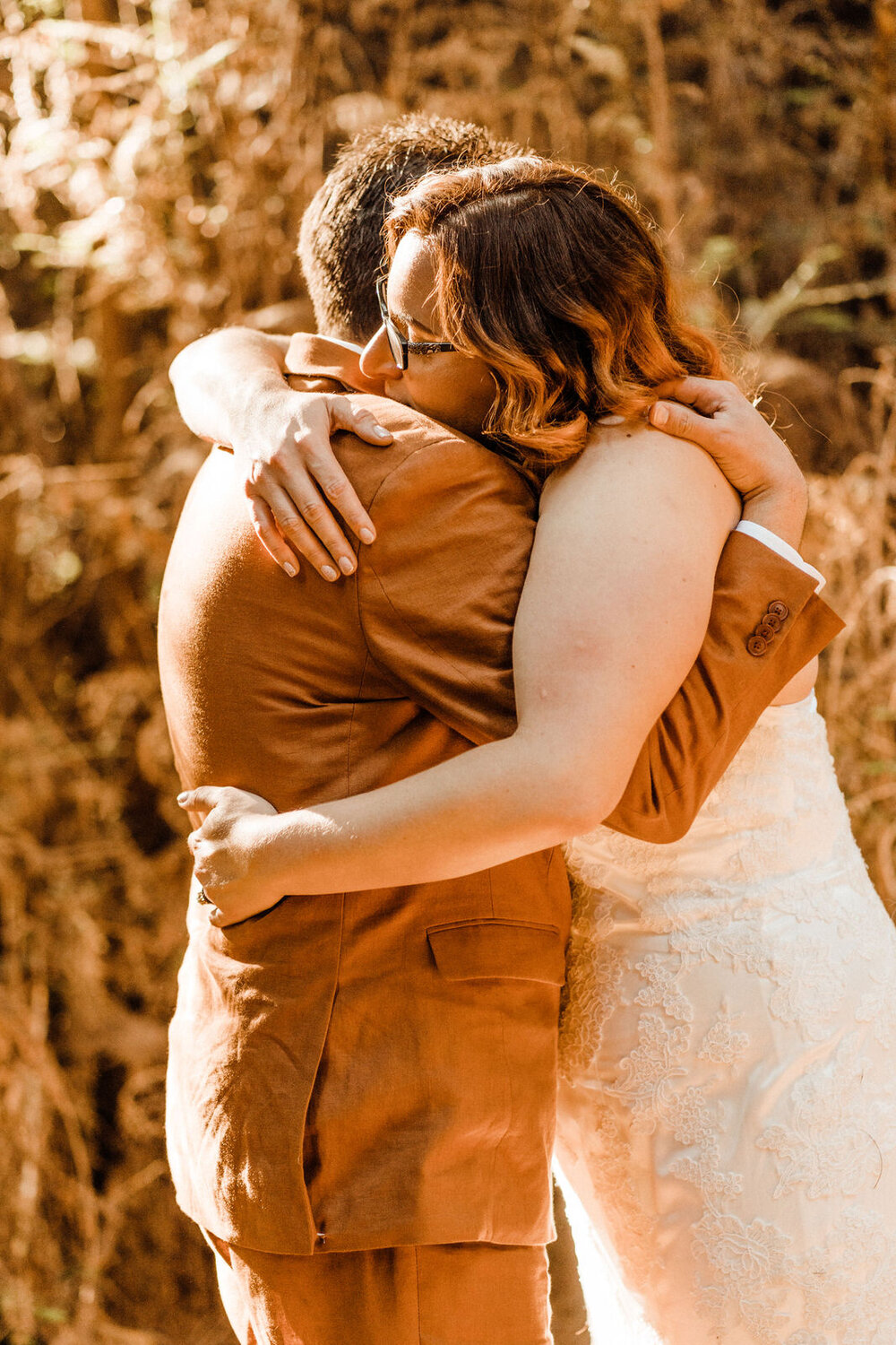 Henry-Cowell-Redwoods-State-Park-Wedding-Santa-Cruz-Bride-and-Groom-Share-Emotional-Hug.jpg