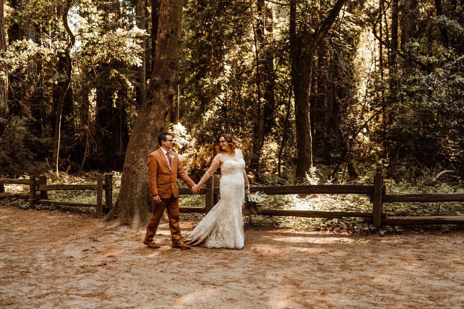 Henry-Cowell-Redwoods-State-Park-Wedding-Santa-Cruz-Bride-in-Strapless-Dress-Leading-Groom-in-Rust-Orange-Suit.jpg