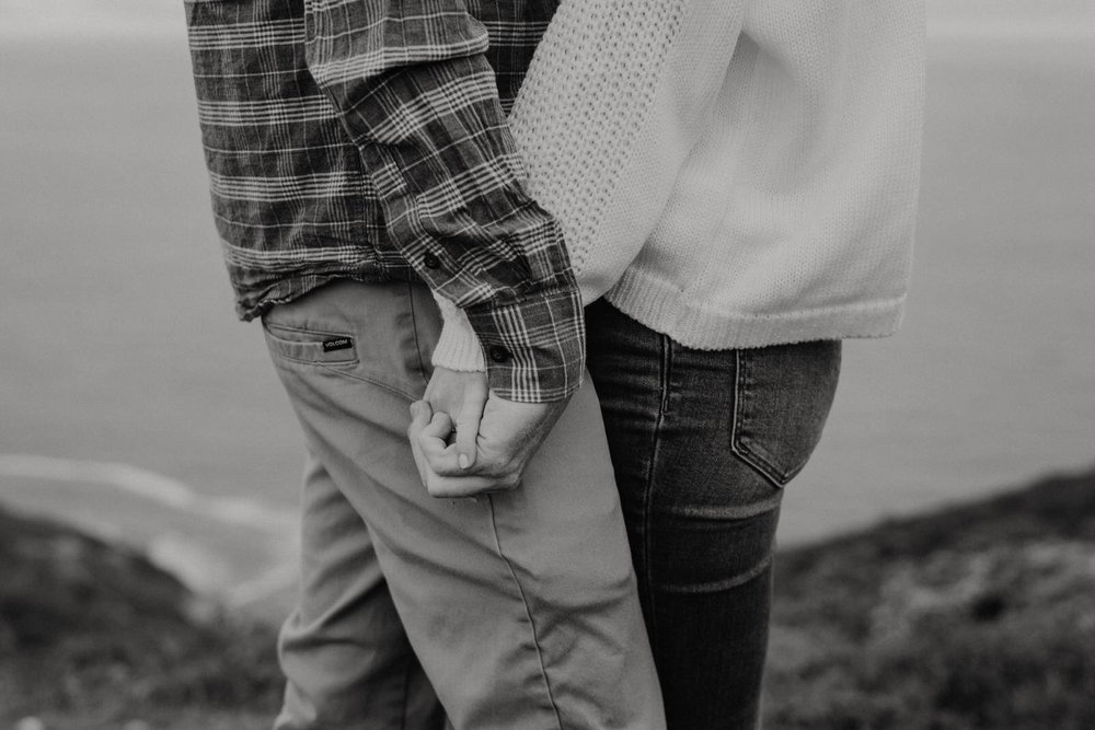 Black and white photo of couple holding hands at Point Reyes Engagement session by Elopement Photographer Kept Record | www.keptrecord.com