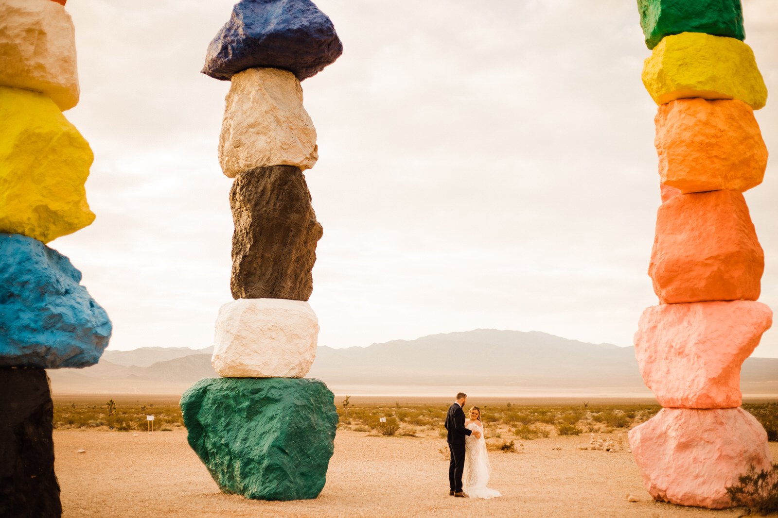 Colorful Seven Magic Mountains Artwork in Vegas, with Bride and Groom sharing first look | Adventurous Elopement Photographer | Las Vegas, NV Wedding | Kept Record | www.keptrecord.com