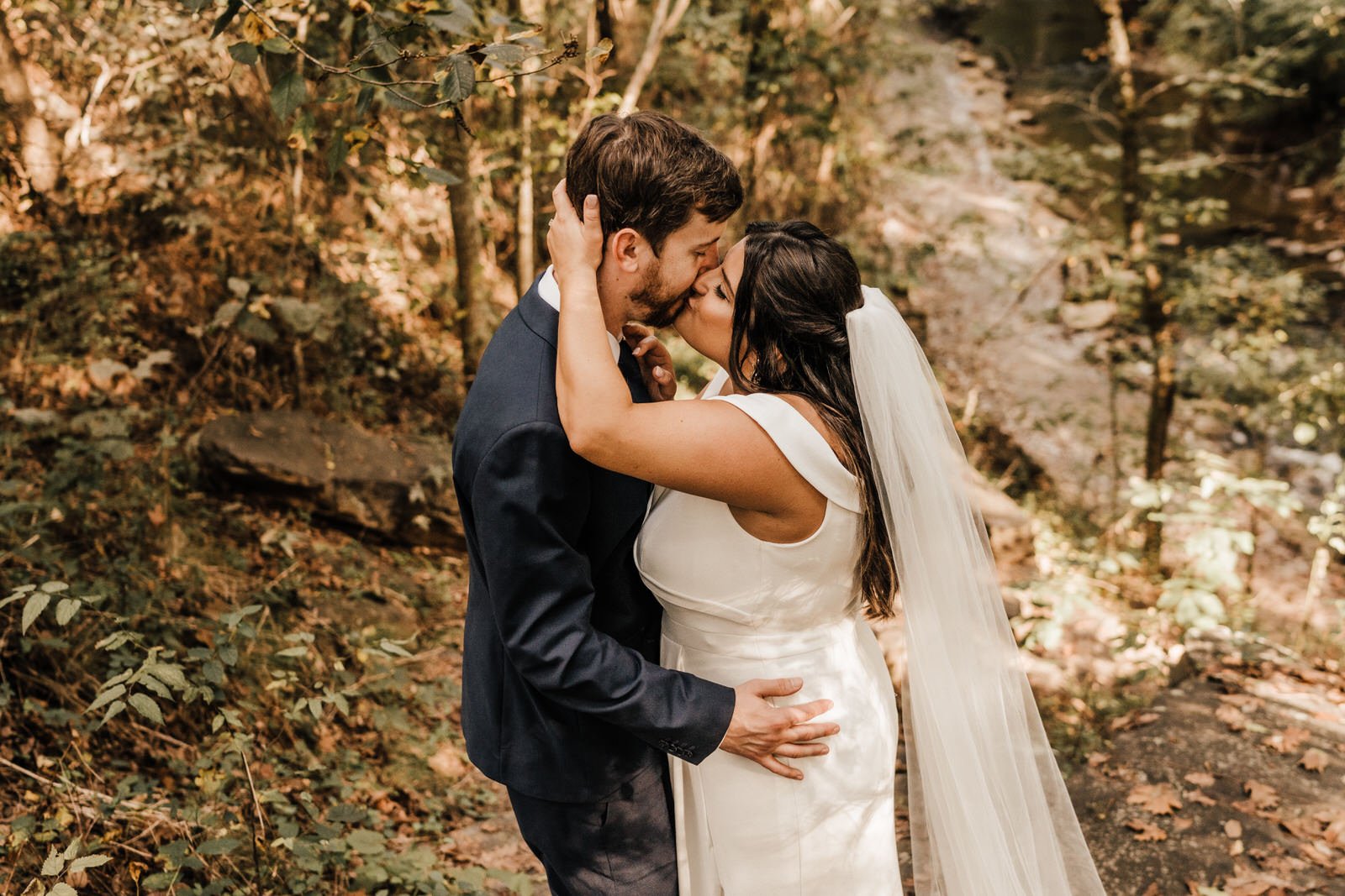 Bride-wearing-off-shoulder-wedding-dress-kissing-Groom-in-Navy-Suit-in-Roswell-GA-Wedding (4).jpg