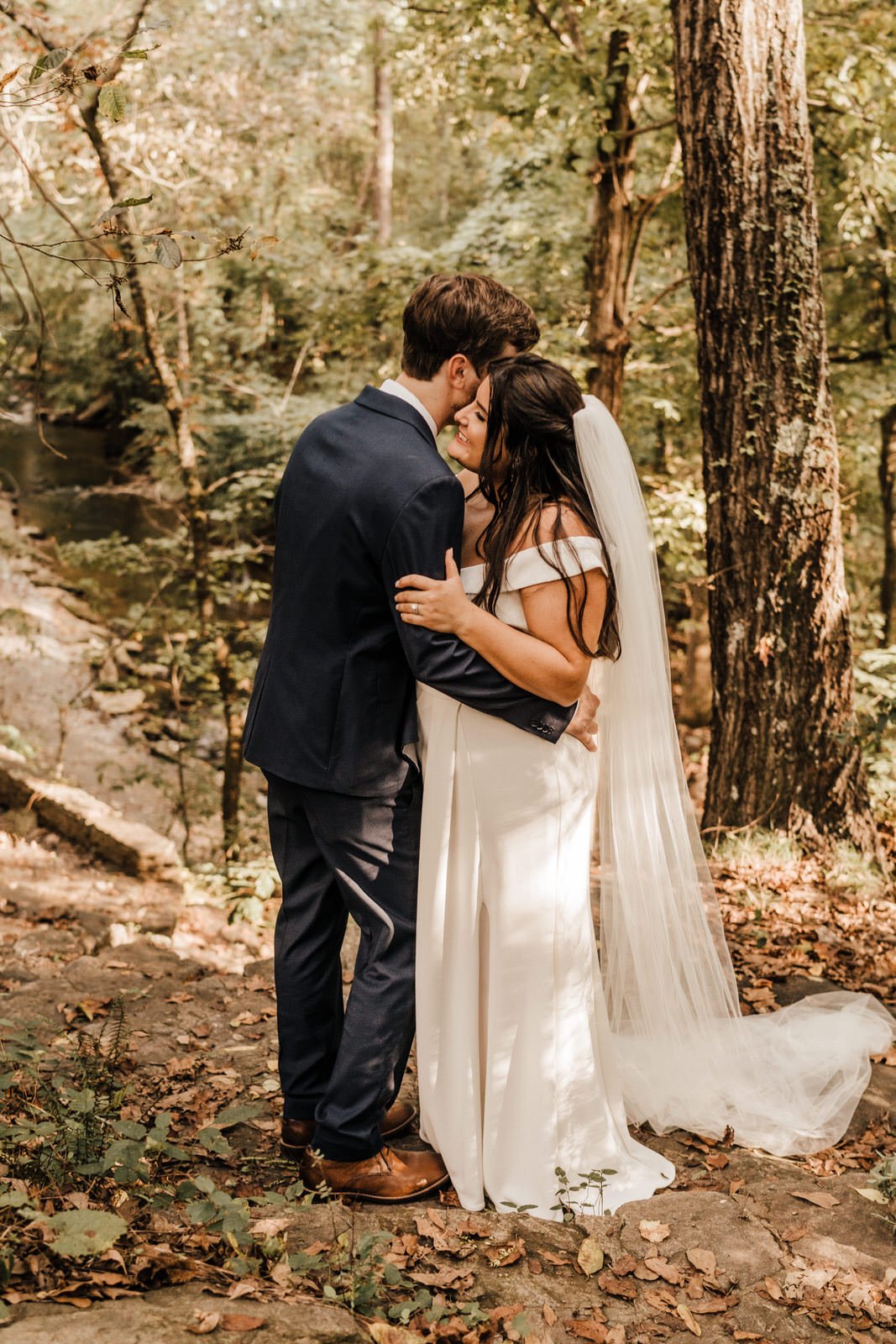 Groom-in-Navy-Suit-Slow-Dances-with-Bride-Long-Veil-in-Roswell-Georgia-Woods-Wedding.jpg