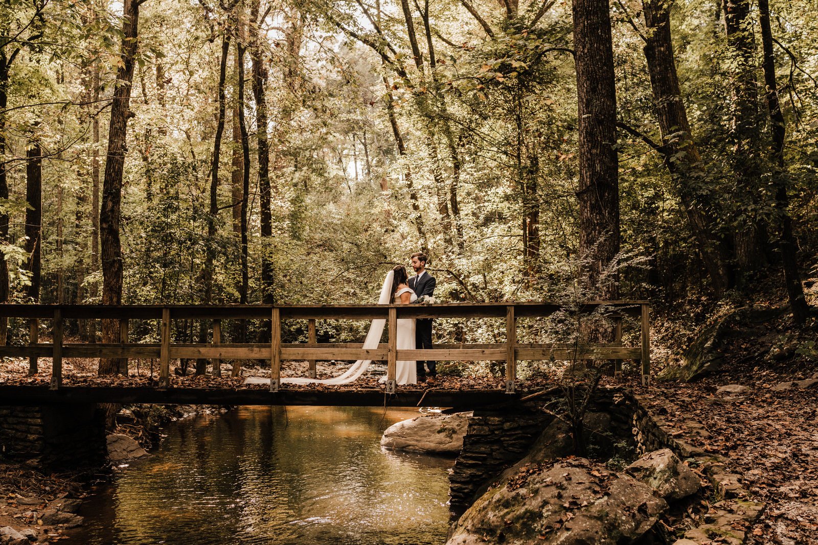 Woodsy-Georgia-Wedding-Bride-and-Groom-on-Bridge-Above-Creek-in-Roswell-Georgia (2).jpg