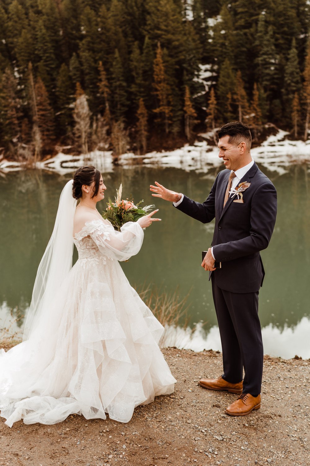 utah-mountain-elopement-bride-and-groom-candid-rock-paper-scissors.jpg