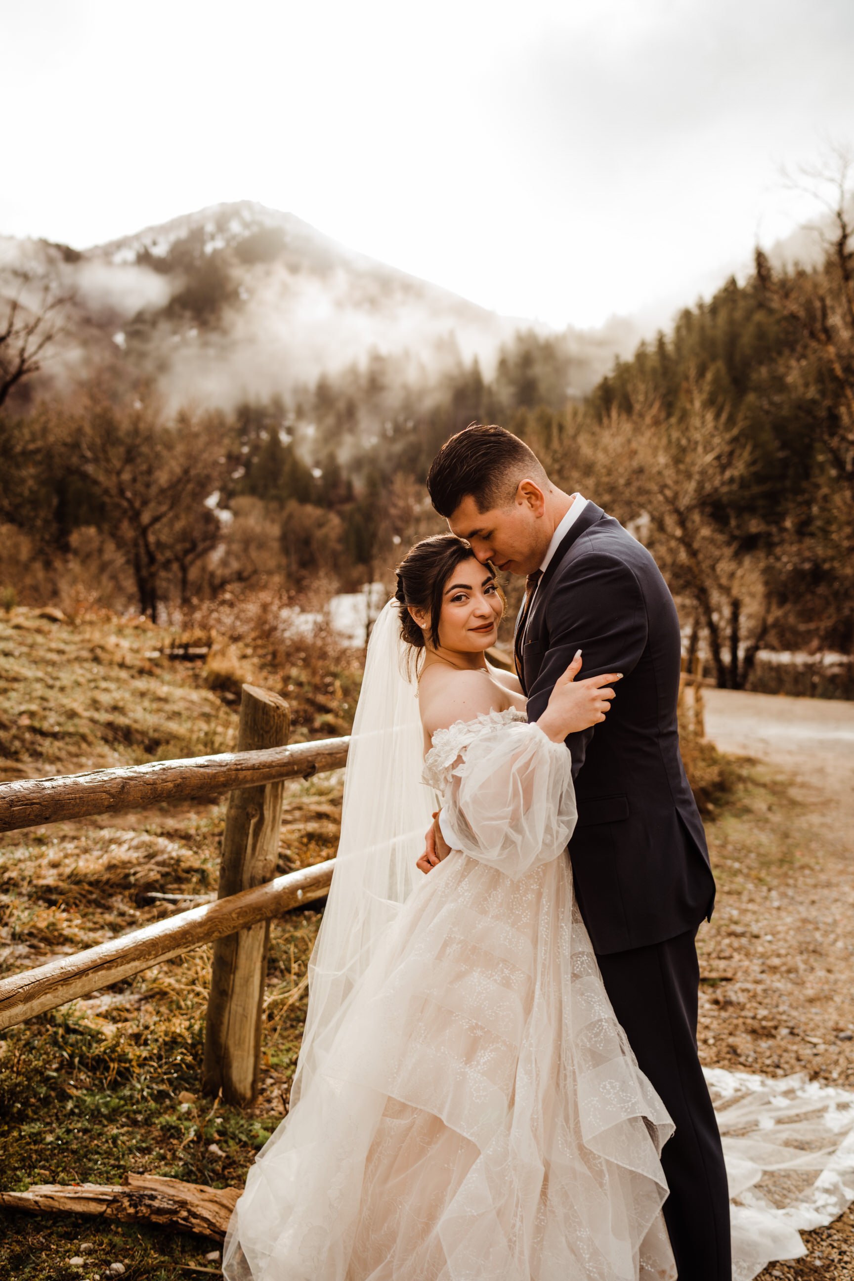 utah-mountain-elopement-bride-and-groom-hiking-in-fog-and-mist.jpg