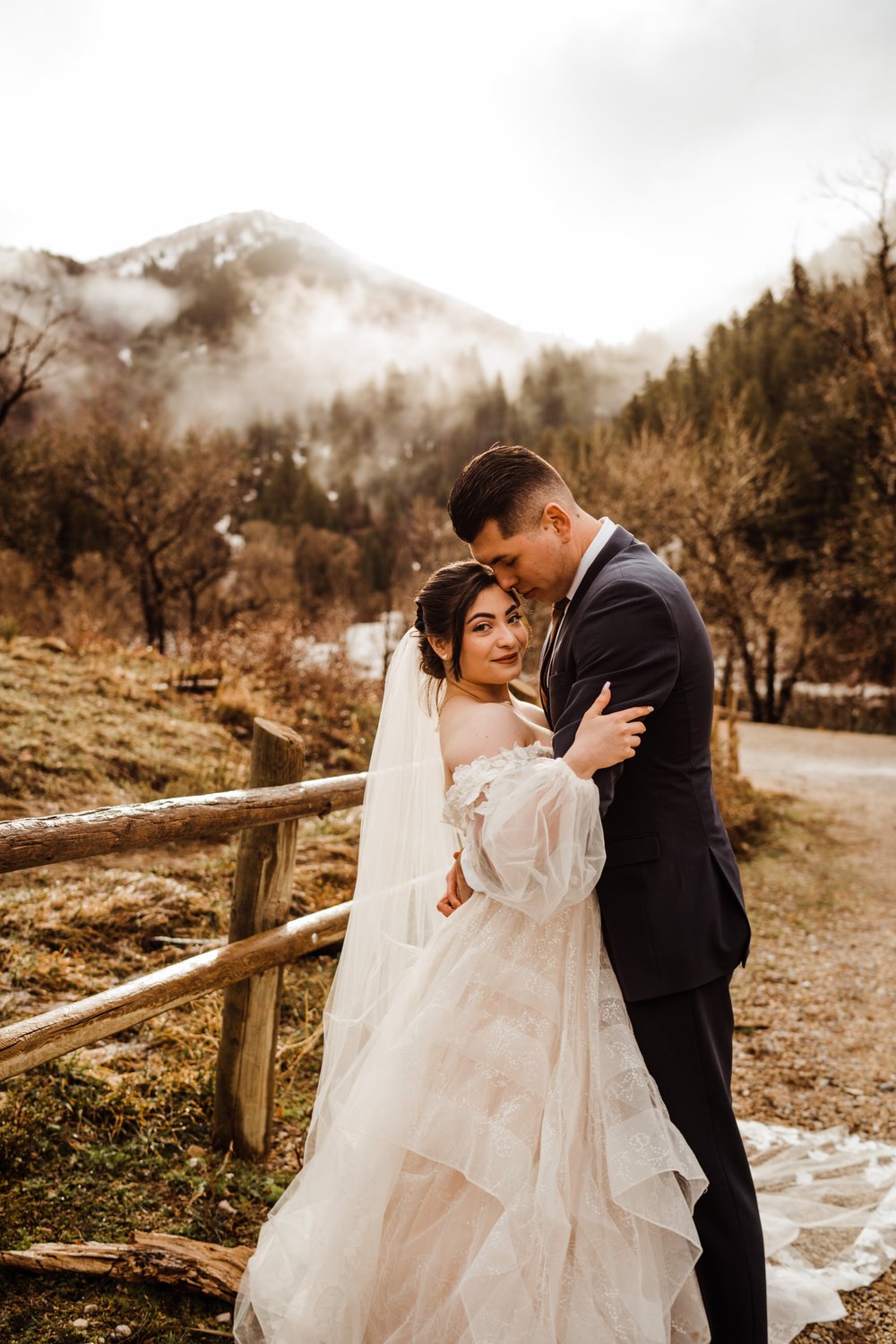 utah-mountain-elopement-bride-and-groom-hiking-in-fog-and-mist.jpg