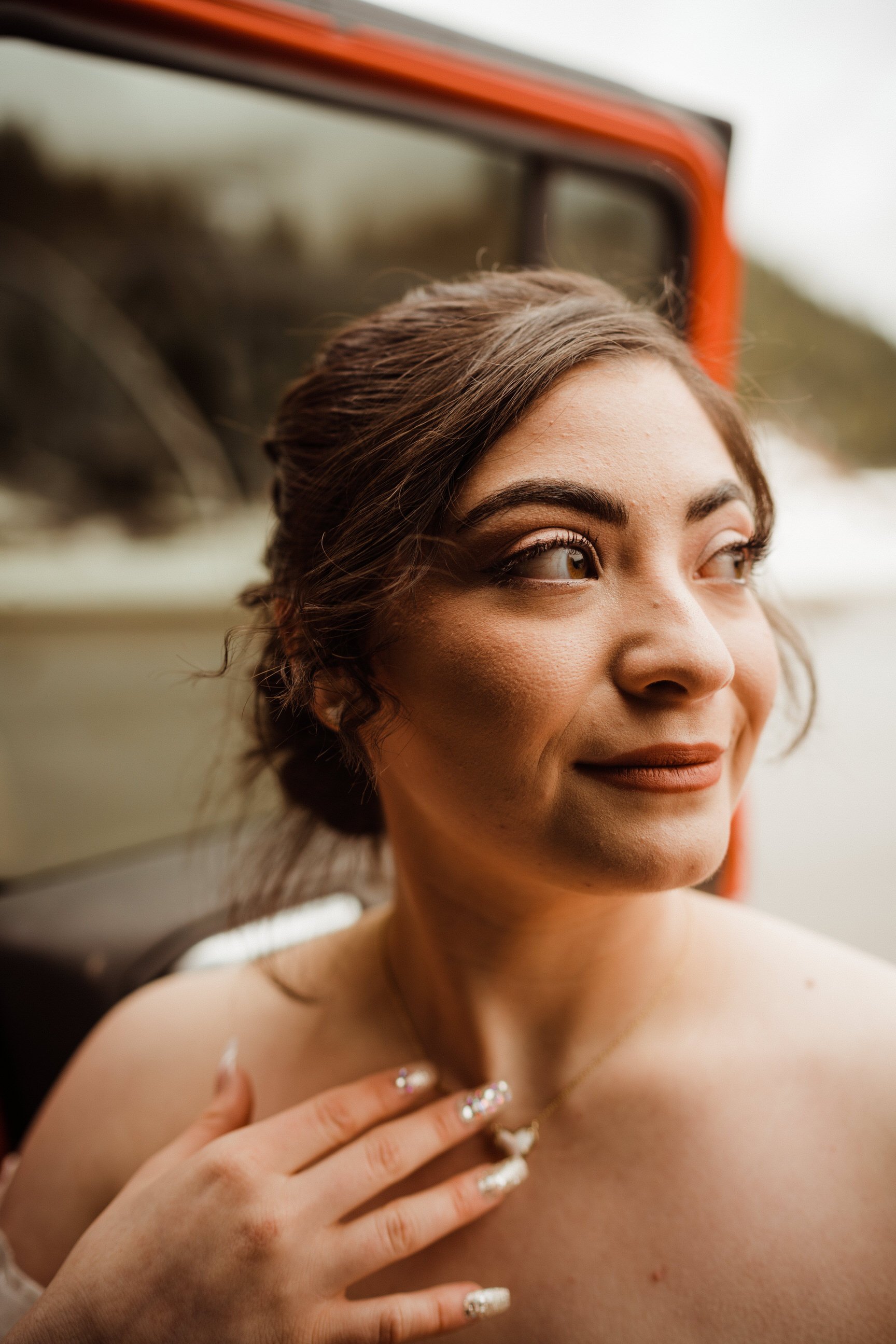 utah-mountain-elopement-bride-with-kendra-scott-necklace-by-red-jeep-wrangler.jpg