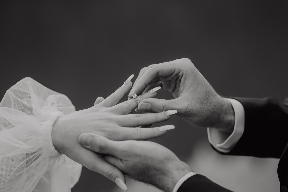 utah-mountain-elopement-groom-puts-brides-ring-on-finger.jpg