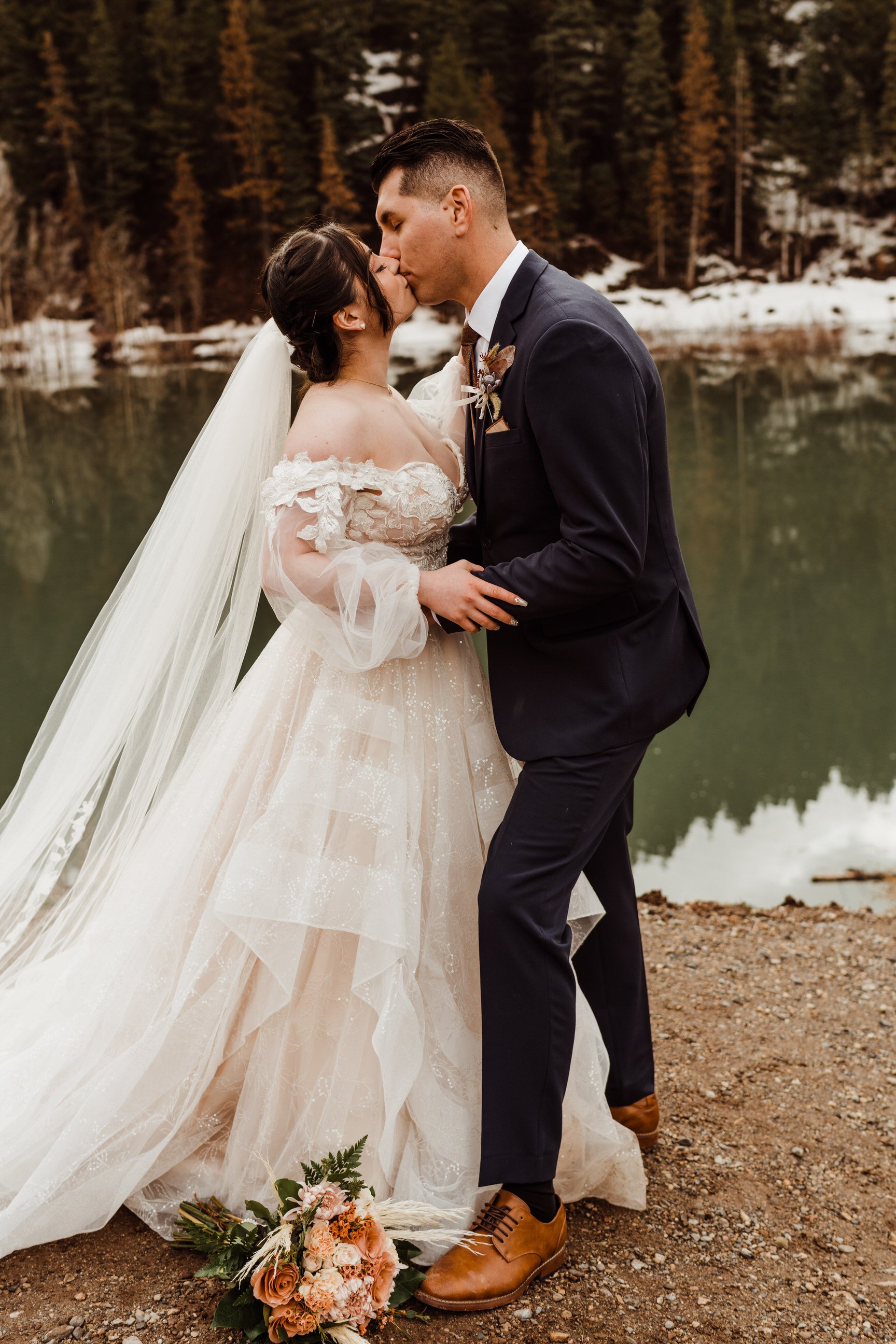 utah-mountain-elopement-photo-of-bride-and-groom-first-kiss-at-ceremony.jpg