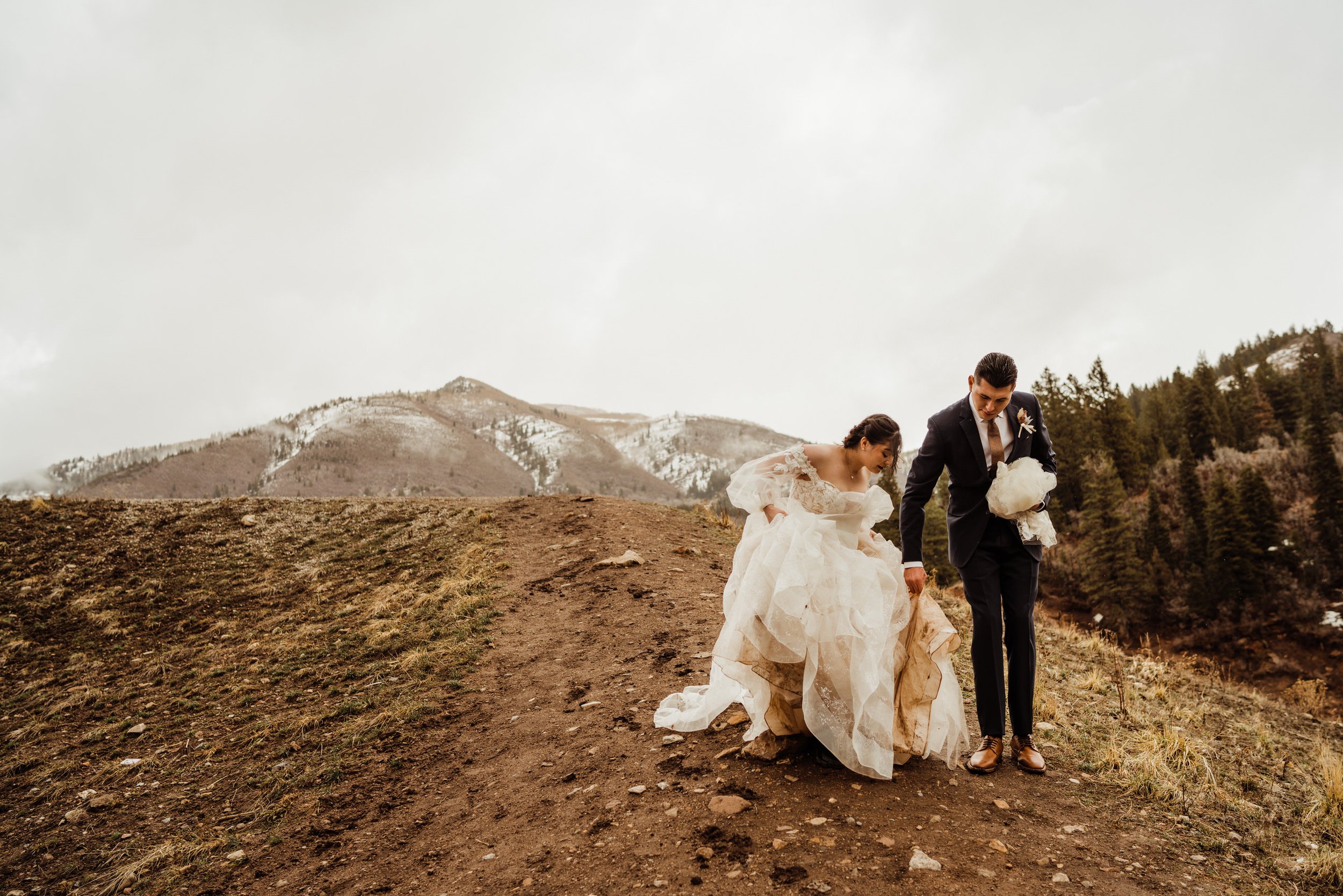 utah-mountain-elopement- adventurous-bride-and-groom-hiking-down-mountain.jpg