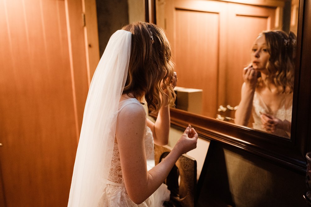 Wedding-in-the-Woods-Bride-in-Mirror-Putting-on-Lipstick (2).jpg