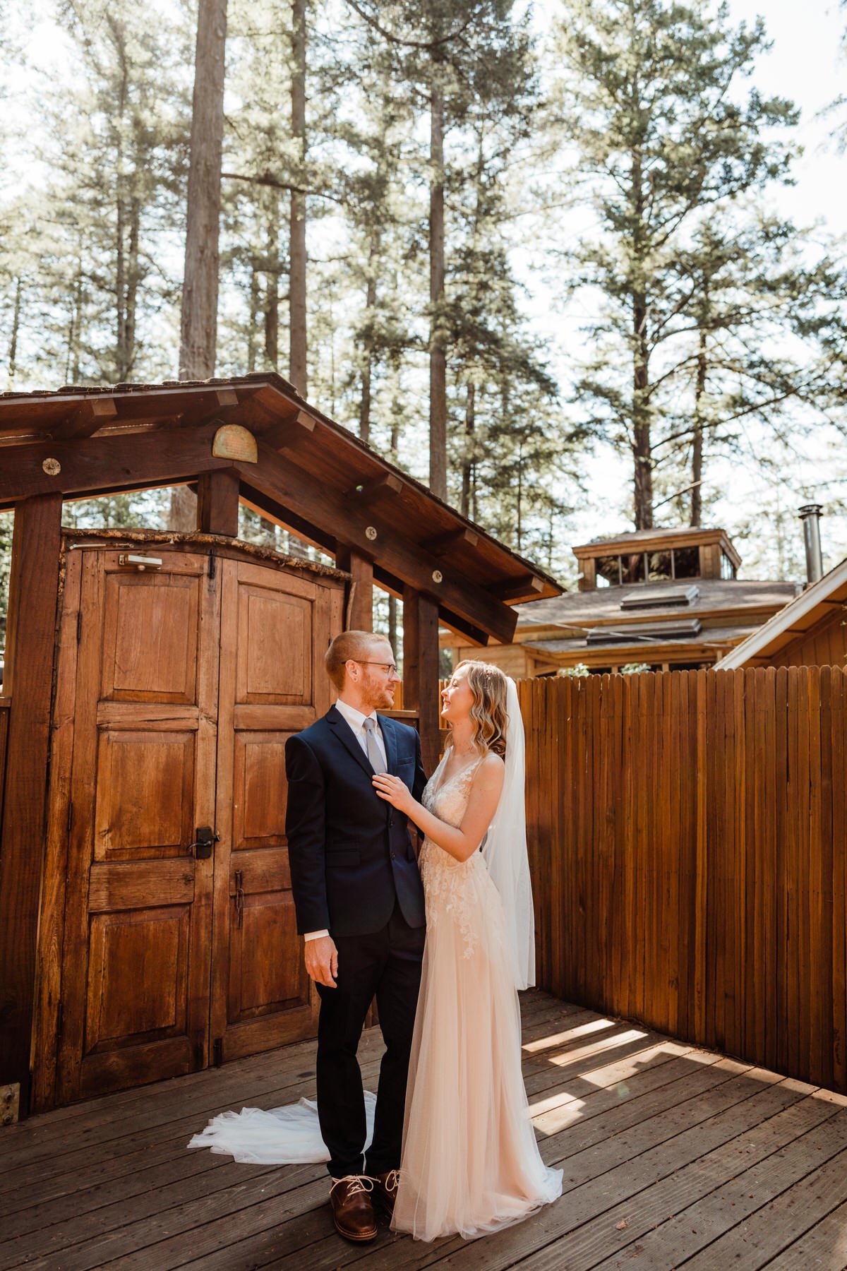 Bride-and-Groom-outside-Redwoods-Airbnb-with-Bali-doors-with-Tall-Trees-in-distance.jpg