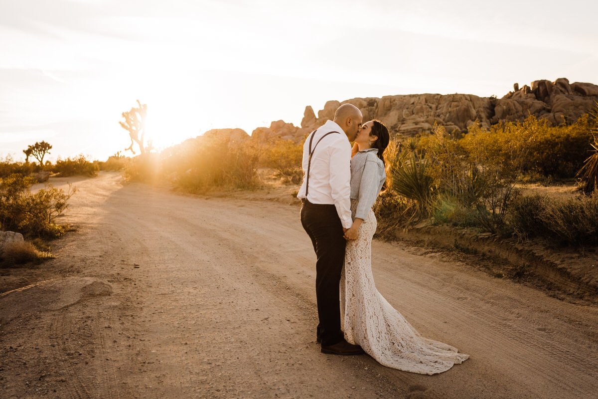 Joshua-Tree-National-Park-Small-Wedding-Bride-and-groom-kissing-on-dirt-road.jpg