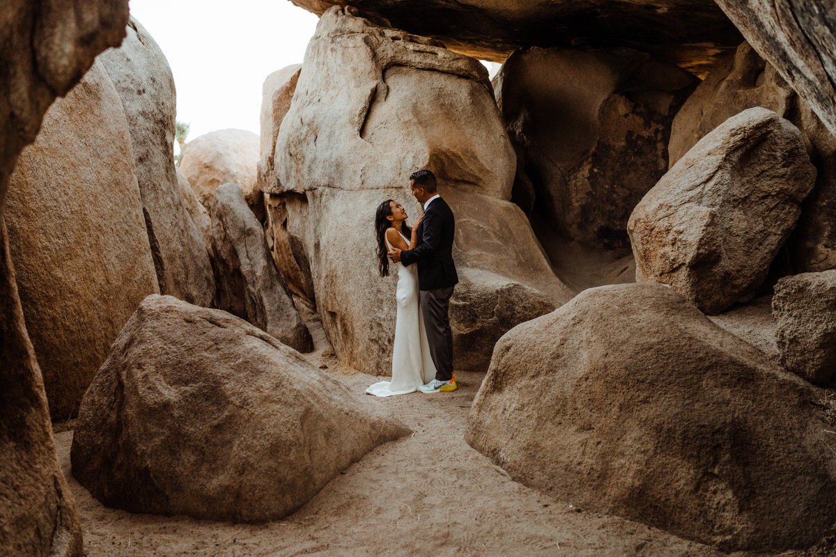 Joshua-Tree-National-Park-Wedding-Couple-kissing-between-boulders.jpg