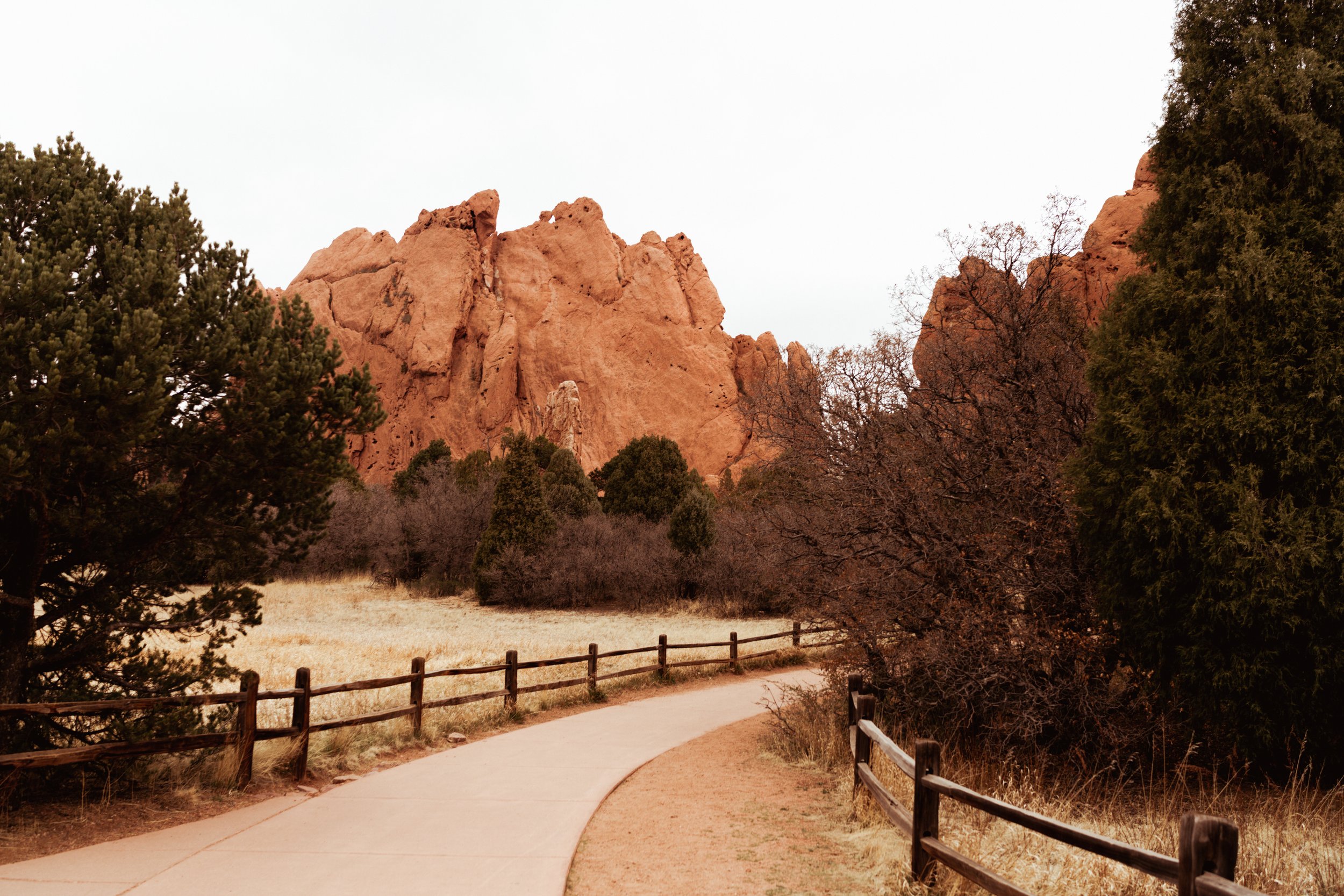 Paved trail pathways through red sandstone geological formations at Garden of the Gods | Adventure photographer Kept Record