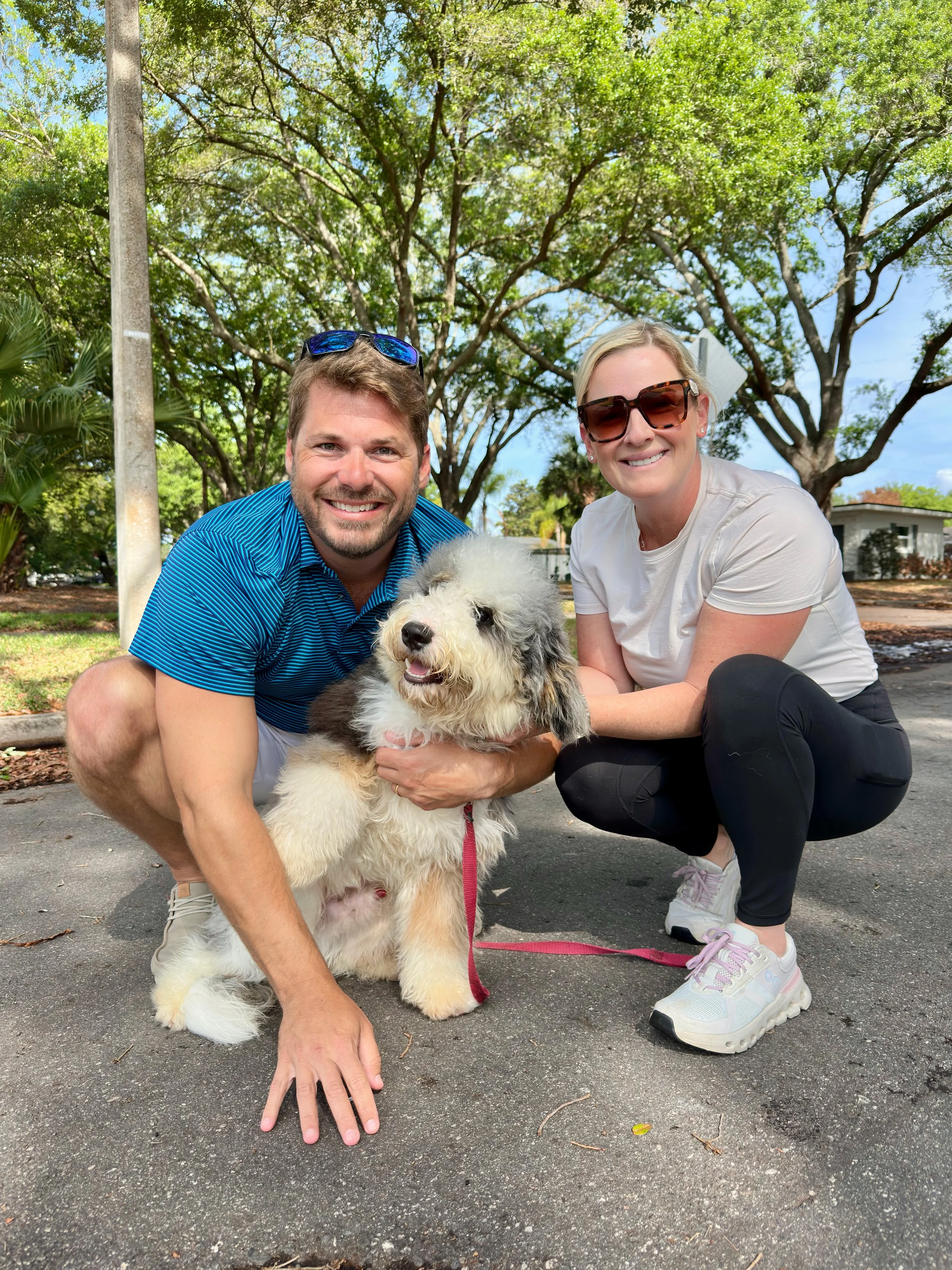 Client sitting confidently with their trained dog demonstrating calm behavior, focus, and improved obedience after professional training.