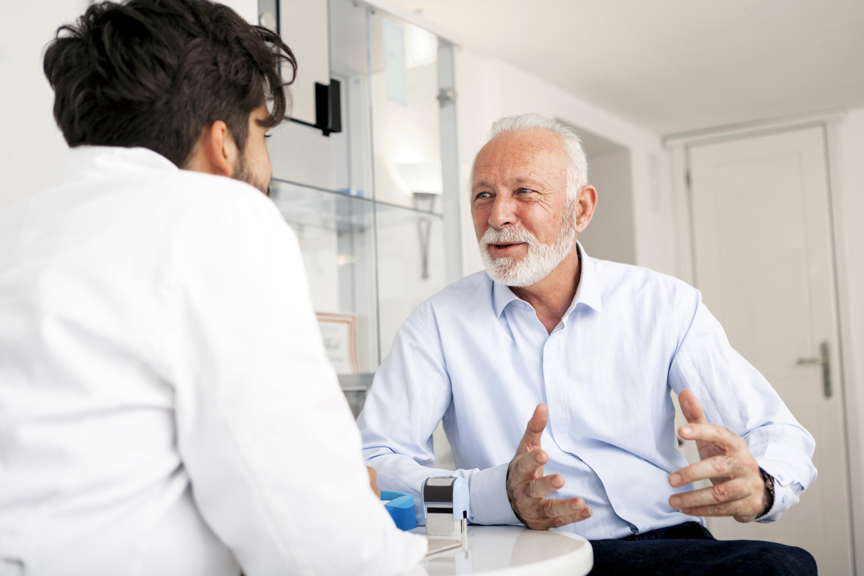Senior-Patient-consulting-With-Doctor-In-Office-898884840_1257x838.jpeg