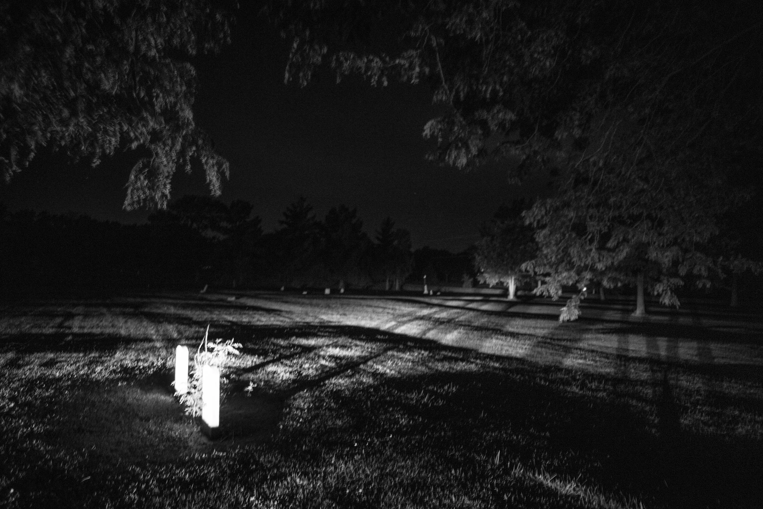 Gravestones as seen at night in Elmwood Cemetery in Mexico, Missouri on Thursday, Jun. 20, 2019.