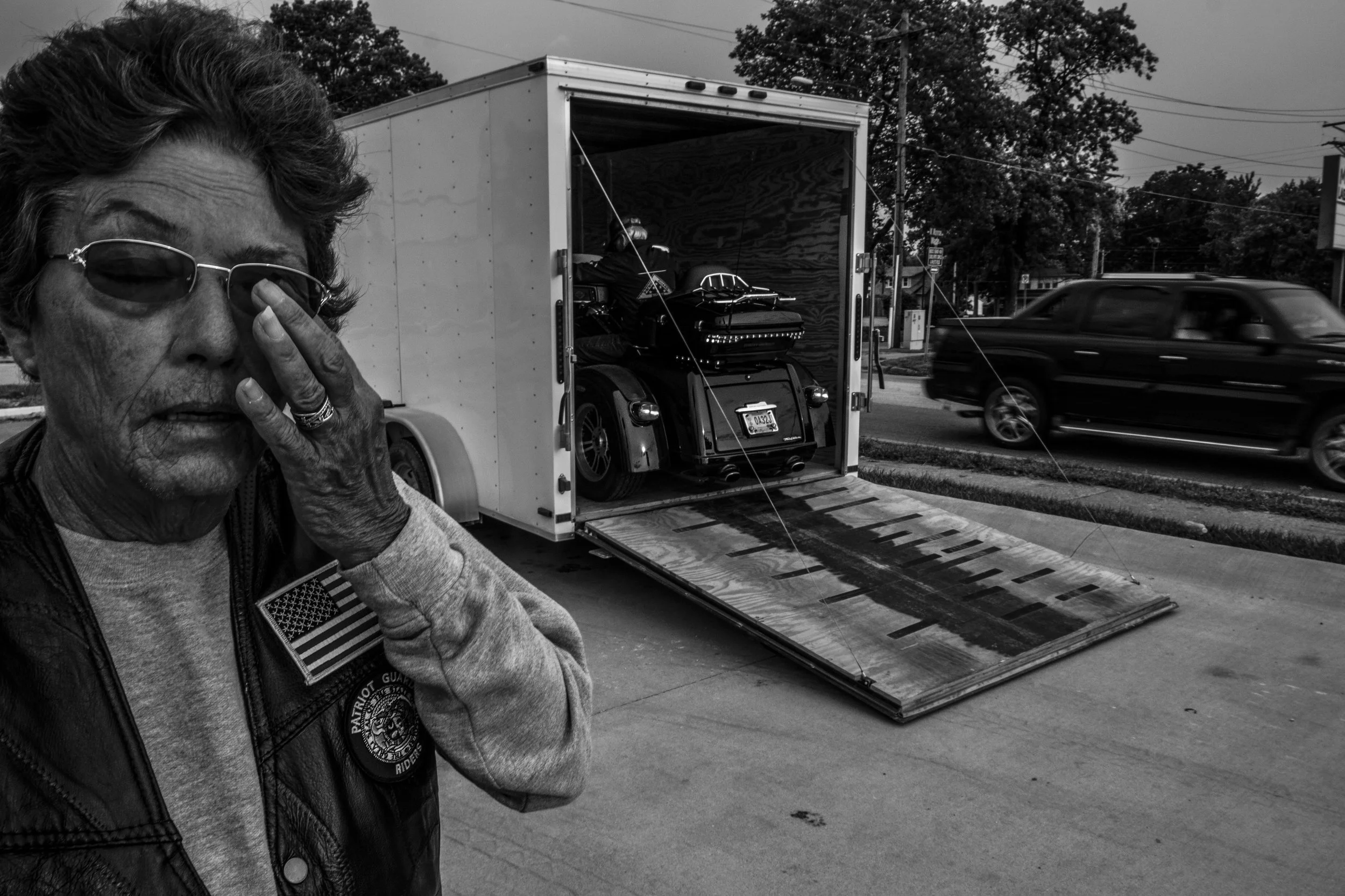 Patriot Guard Rider, Kay Walden, waits for her husband, Bill, to unload their motorcycle for an early morning ride around Mexico, Missouri on Friday, Jun. 21, 2019.