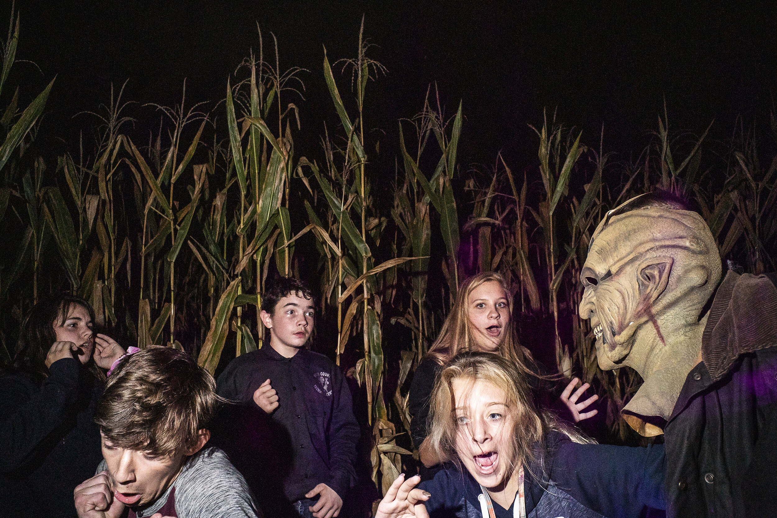  (Left to right) Janessa Ross, Eric Carson, Michael Rollyson, Brooklyn Camp and Eva Sheeter react to Field of Screams volunteer, Seth Coleman, jumping down from his scarecrow platform on Saturday, October 5, 2019. (James Year/Ohio University) 