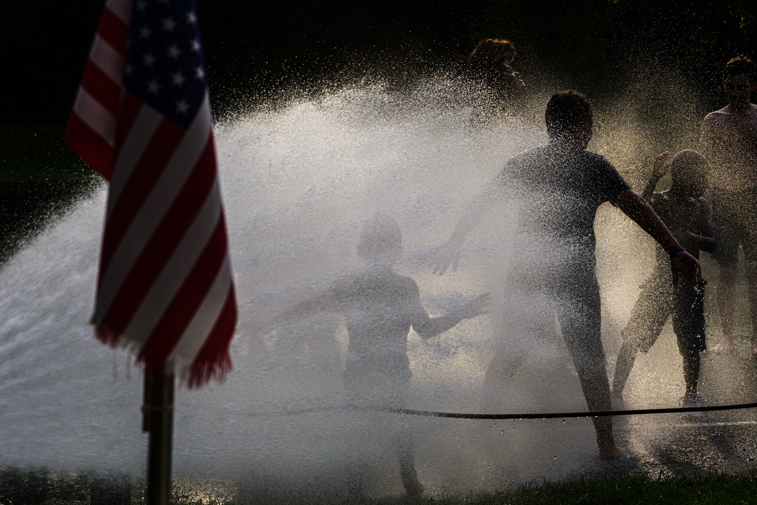  Ezra Smith, 5, runs through the cool water being sprayed by a firehose during a Juneteenth Block Party at Sherman Oliver Ross Park in Cynthiana, Kentucky on Saturday, June 19, 2021.   The event marked the first celebration of Juneteenth in Cynthiana
