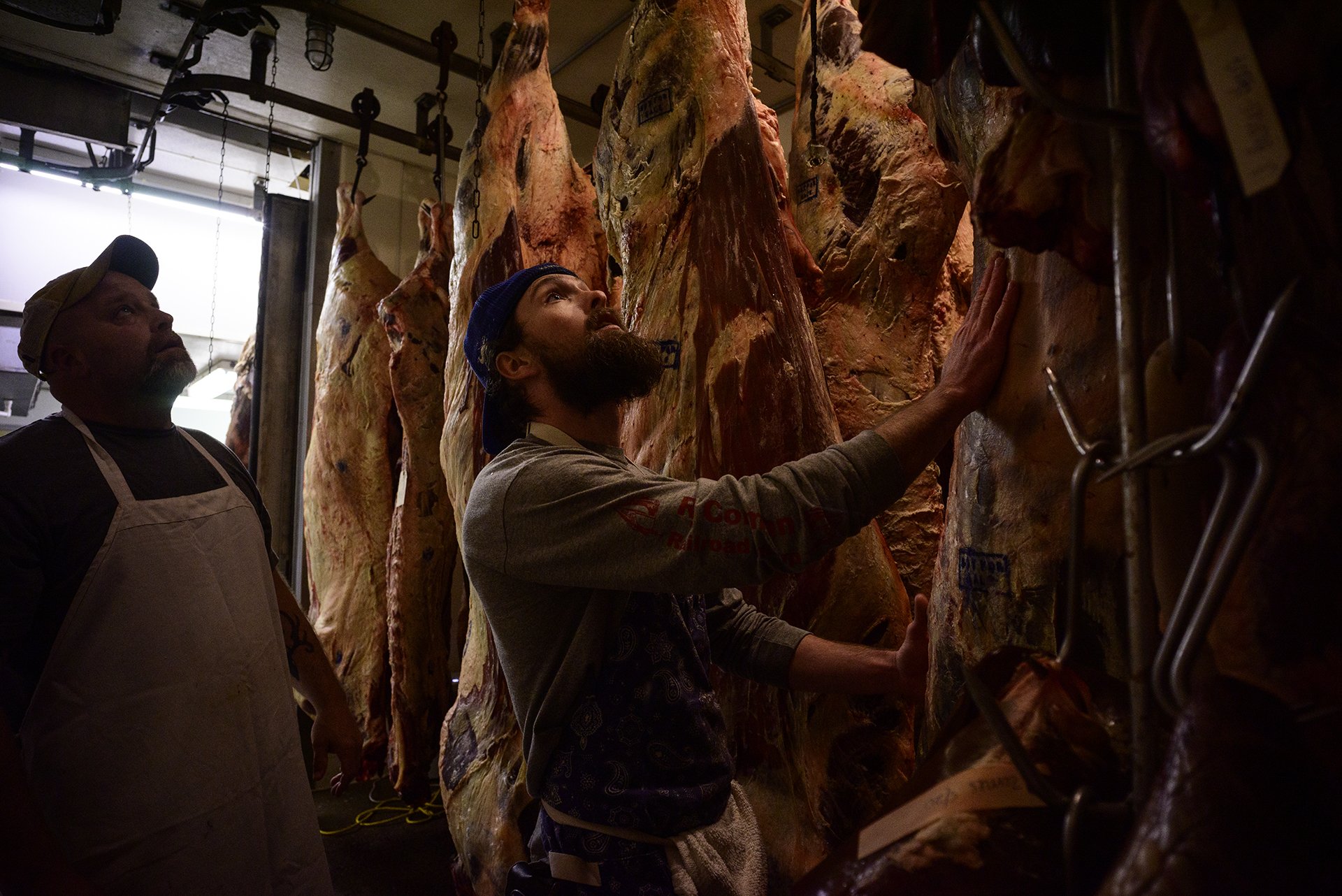  Joe Wood and Jesse Florence rearrange some beef to get to the order needed for processing at the Riverview Meat Company on Tuesday, May 25, 2021.   The Riverview Meat Company is Harrison County's only meatpacking establishment. The meatpacking indus