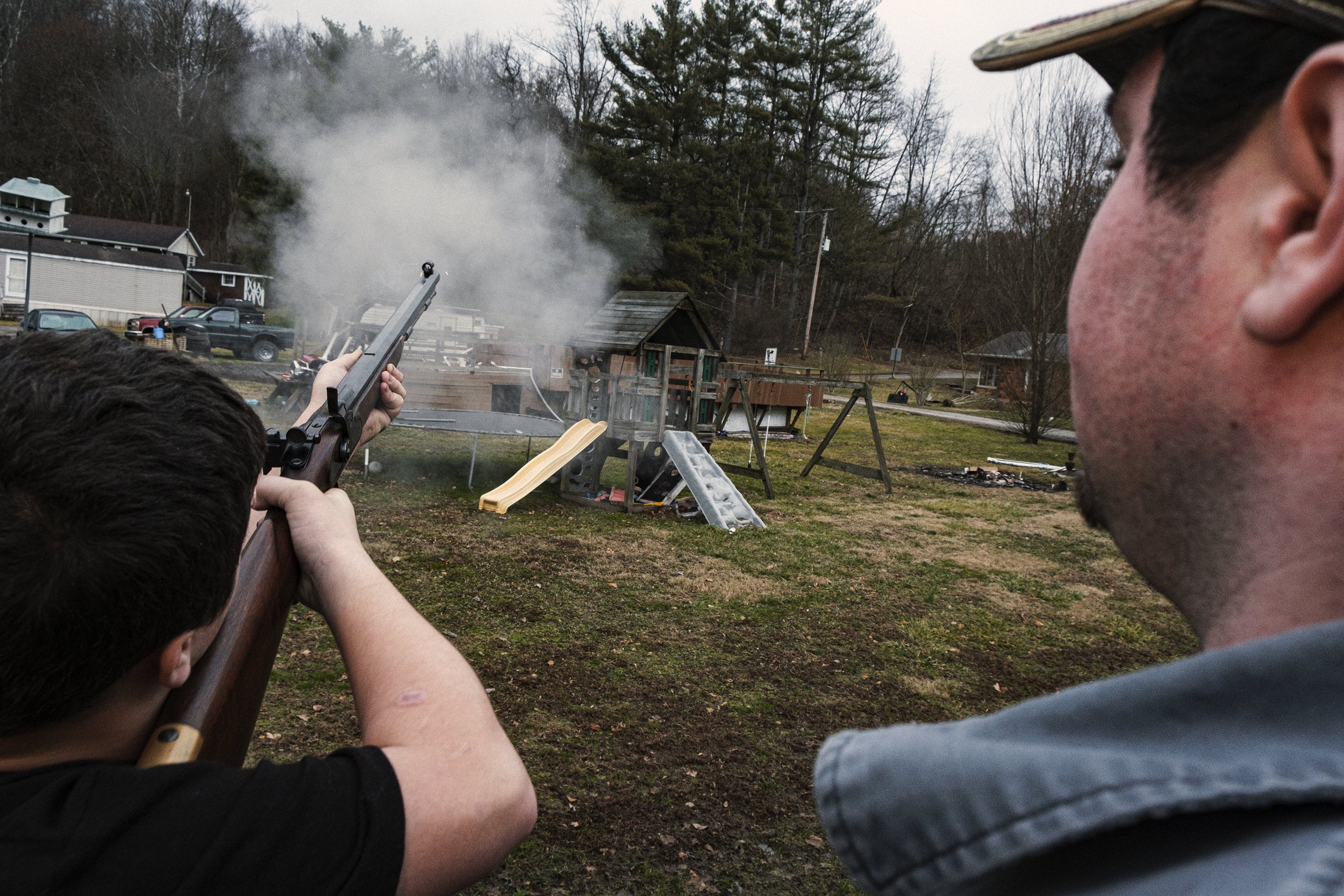  Nate “Nader” Hayslip, 13, fires a 45 Caliber muzzleloader into the hills and over a residential area with Robert Lawson in Haydenville, Ohio on Saturday, February 1st, 2020. Haydenville was the last operating company town in the state of Ohio and is